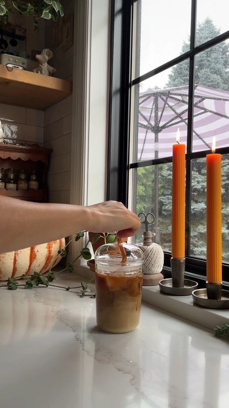 Cozy fall vibes in the kitchen. It was rainy and gloomy this morning so I set the mood with fluted taper candles from Anthropologie. I love them!

And it can be -45C and I’ll still be making an iced coffee. But I did use a fun fall creamer in my glass domed cup with a brown squiggly straw for extra fall vibes  

#LTKhome #LTKSeasonal #LTKHalloween