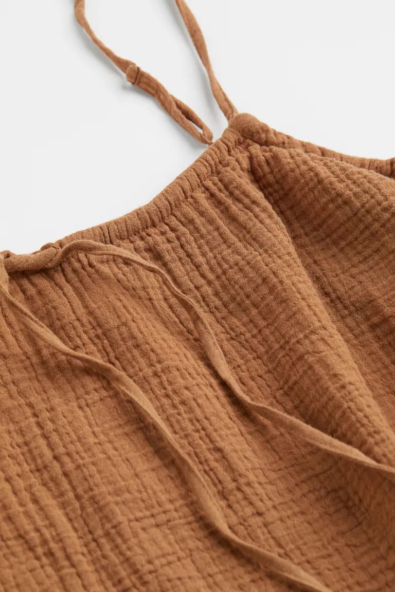Relaxed-fit camisole top in soft woven fabric. Narrow, adjustable shoulder straps, round neckline... | H&M (US + CA)