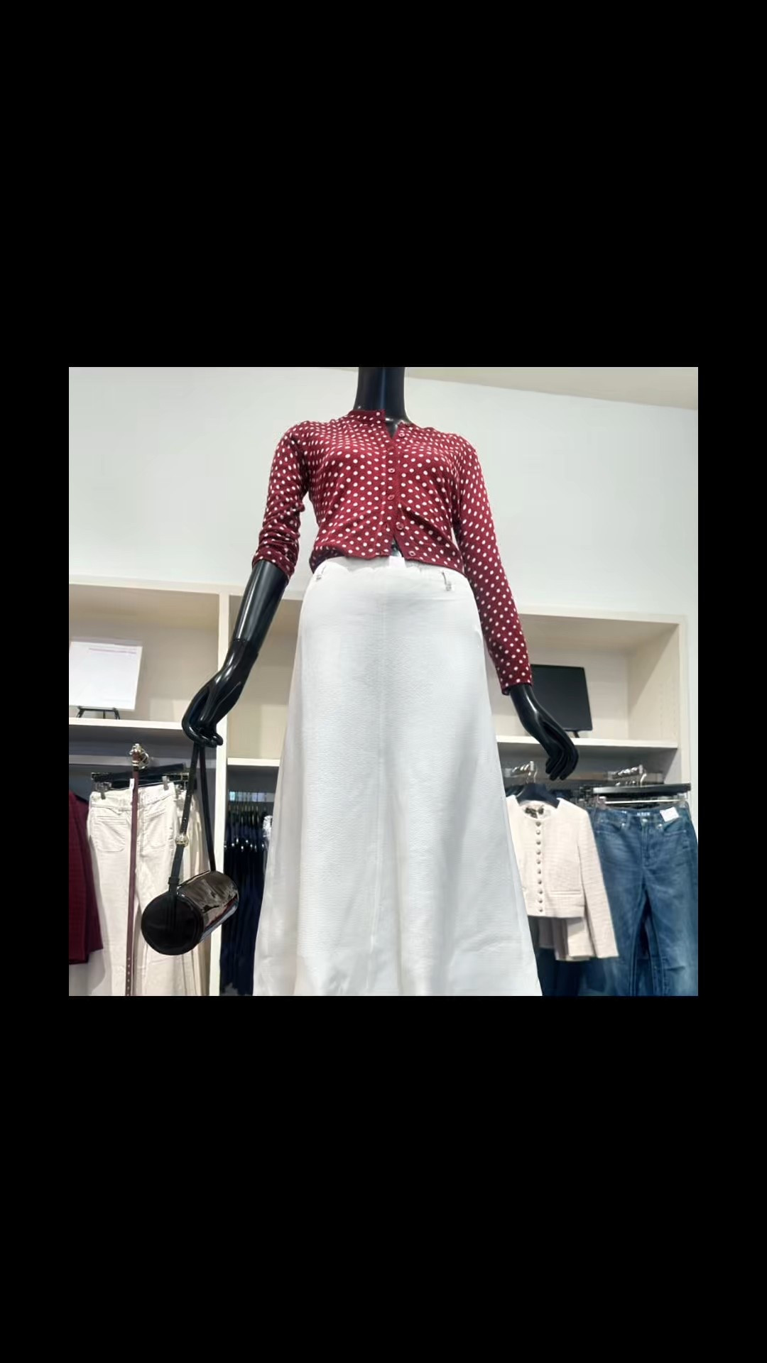 Polka dot deep burgundy sweater over a white skirt. Crisp and classy.