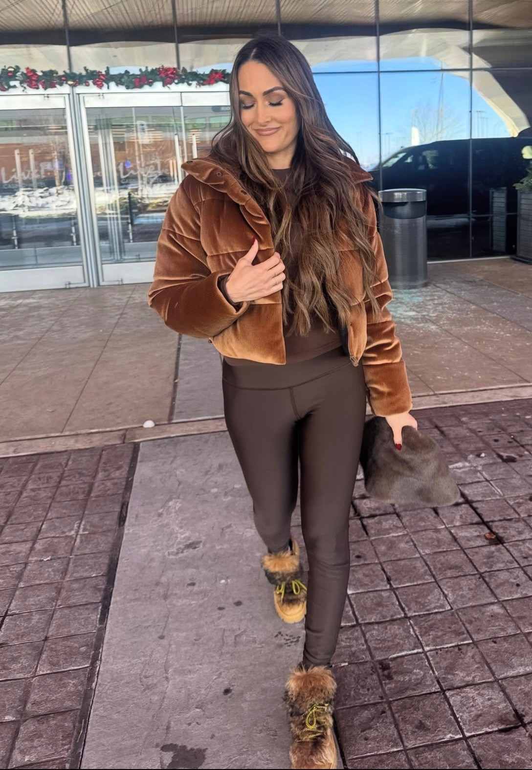 Nikki Bella's crop puffer jacket, leggings, shearling lace up winter boots
