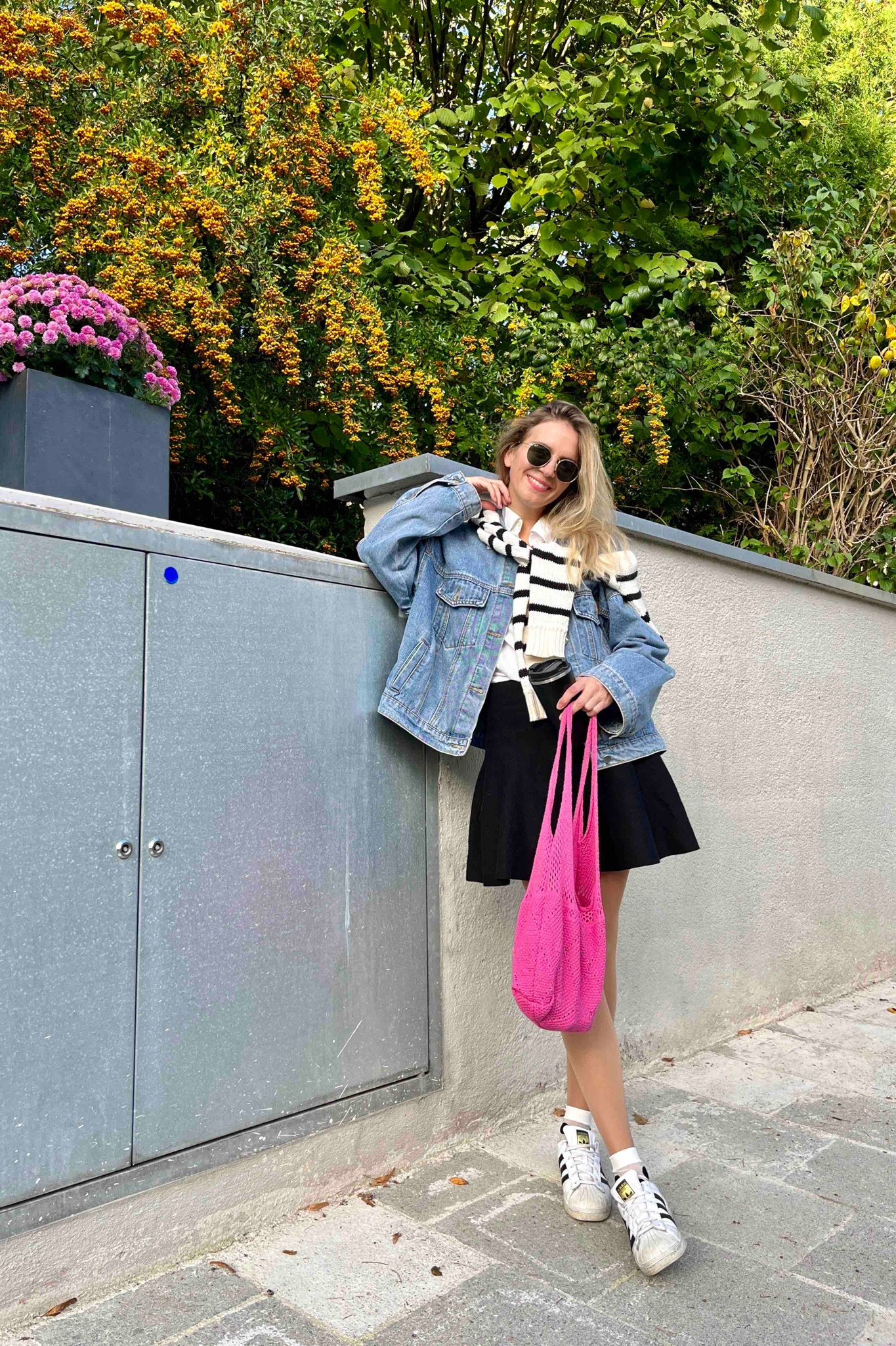 Polka Dot Socks. Fashion Blogger Girl by Style Blog Heartfelt Hunt. Girl with blond hair wearing an oversized denim jacket, Ray-Ban sunglasses, striped sweater, skirt, pink crochet bag, polka dot socks and adidas sneakers. #colorfuloutfit #colorfulstyle #colorfulfashion #colorfullooks #fashionfun #cutefalloutfit #fallfashion2023 #falllookbook #fitcheck #dailylooks #dailylookbook #contentcreator #microinfluencer #discoverunder20k