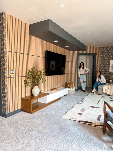 Modern midcentury basement renovation complete with a modern media console and a geometric shag rug. 


#LTKsalealert #LTKhome