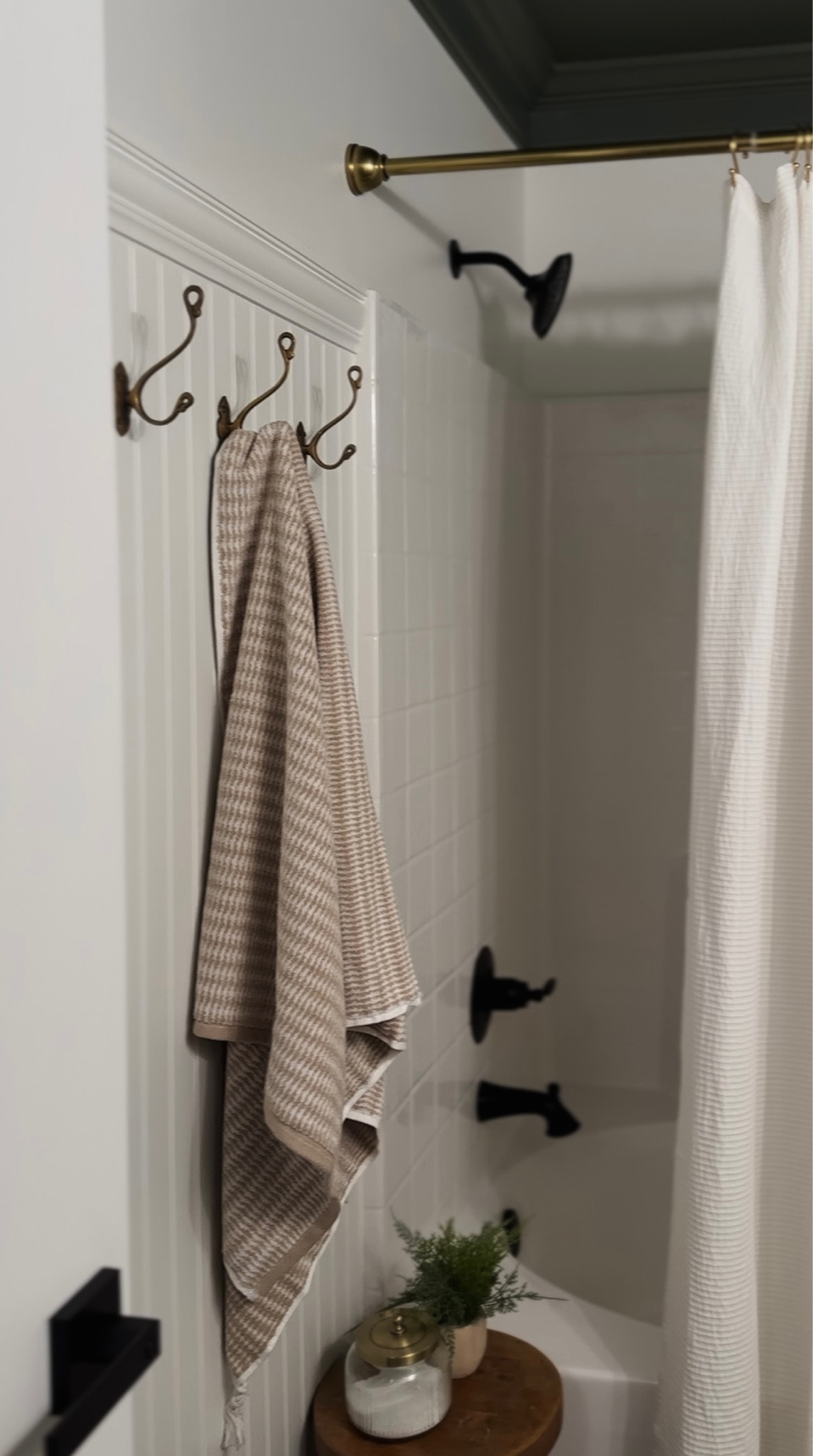 Guest bathroom reveal! 

Turkish towel, vintage brass towel hooks, beadboard, crown molding, black delta shower fixtures, brass shower bar, textured white shower curtain, wood stool, glass bath salt jar, hearth and hand, surya rug, target home, Amazon home, 

#LTKhome #LTKstyletip