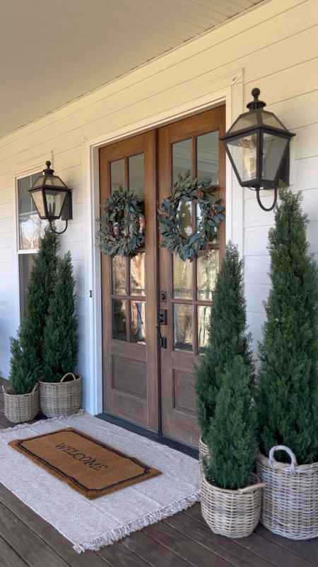 Winter Front Porch! Love these gorgeous cedar trees! I have the 3’ 5’ and 6’ and the quality is so good! They’ve been outside for almost two years! Faux artificial and silk indoor outdoor trees plants and flowers double layered jute rug and doormat eucalyptus berry wreaths rattan resin baskets front porch and door decor home accents spring front doors evergreen trees outdoor wall sconce lantern light fixtures

#LTKMostLoved #LTKstyletip #LTKhome
