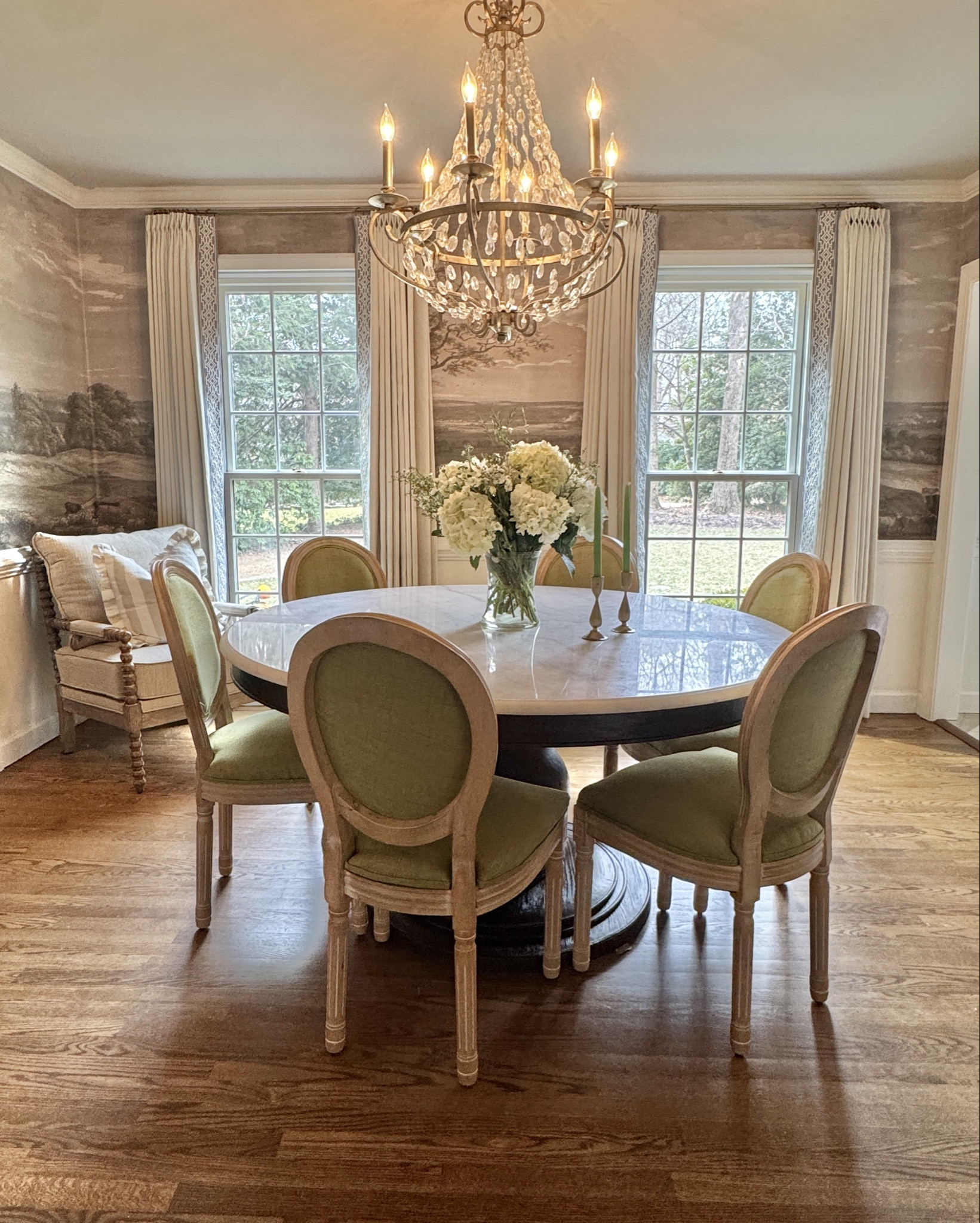 It’s hard to believe this room once had carpet, a closet, and a single small door.

Now it’s layered with marble, bold green chairs, mural wallpaper, and soft pleated curtains. It feels intentional, elevated, and very much us.

We’re loving this bedroom-turned-dining-room transformation, and I hope it inspires you to look at the rooms in your home a little differently.

#LTKHome
