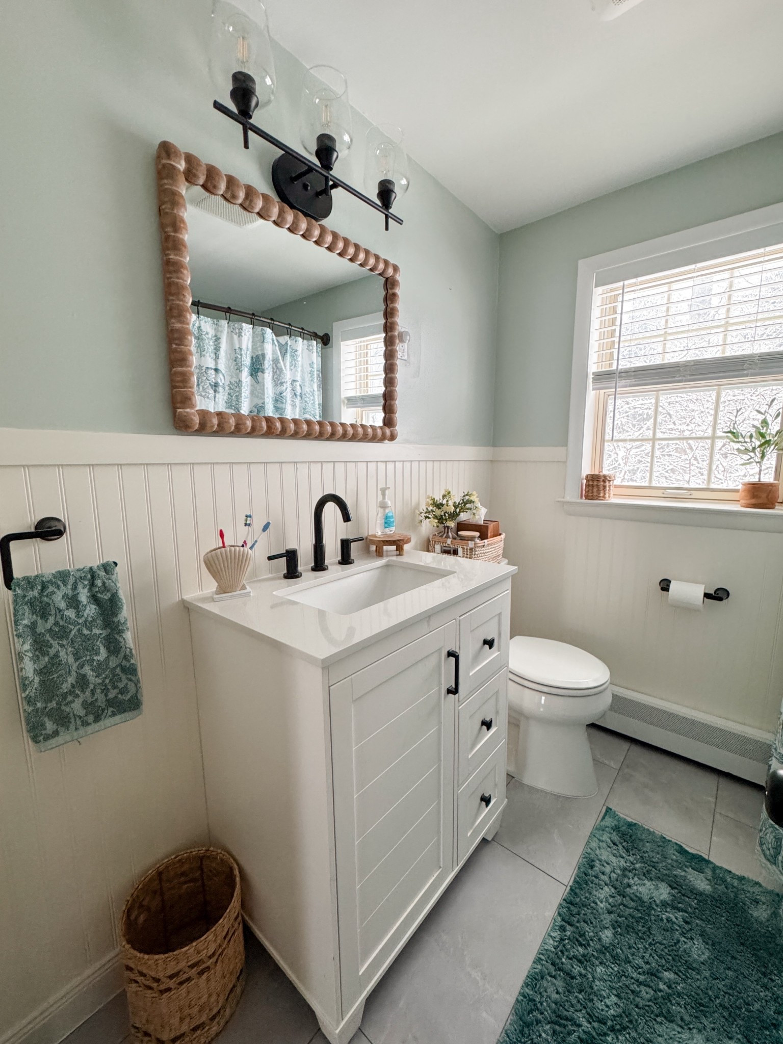 Our new bathroom decor from our remodel! Love how everything turned out. The wooden beaded mirror and beadboard really finishes the space! I love all the texture. Even linked the bathroom vanity, and bathroom light fixture  

#LTKHome #LTKSeasonal #LTKSaleAlert