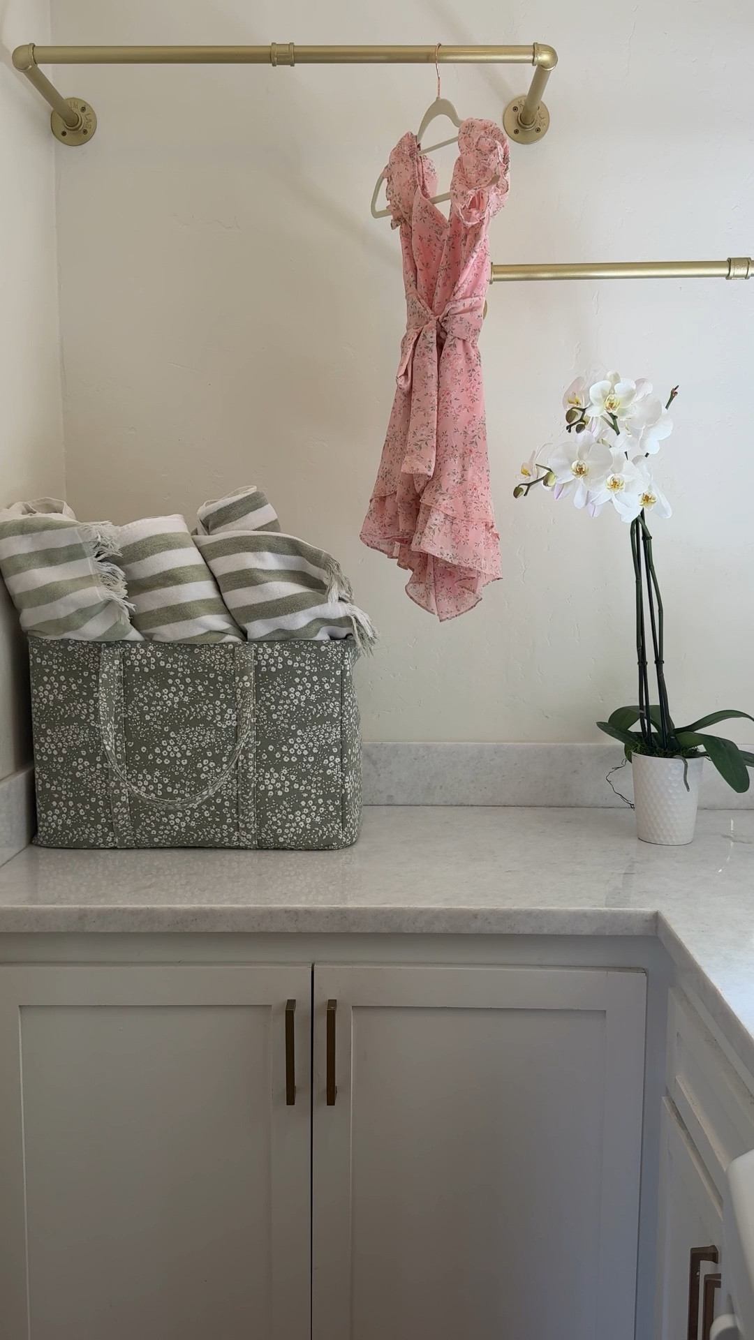 I remodeled my laundry room which desperately needed it. Think 1987 brown cabinet vibes! 🤍

I added new white marble countertops, white cabinets, a sink, Serena and Lilly light fixtures, new brass hardware, and and brass pipe towel racks for hanging clean clothes .🌿

I’m so happy with how my laundry room refresh turned out. Check out the before pictures on my Insta account @marneys_tidbits 🌸

#laundrybasket #fakeflowers #fauxorchids #towels #cabinethandles

#LTKgrwm #LTKSaleAlert #LTKHome