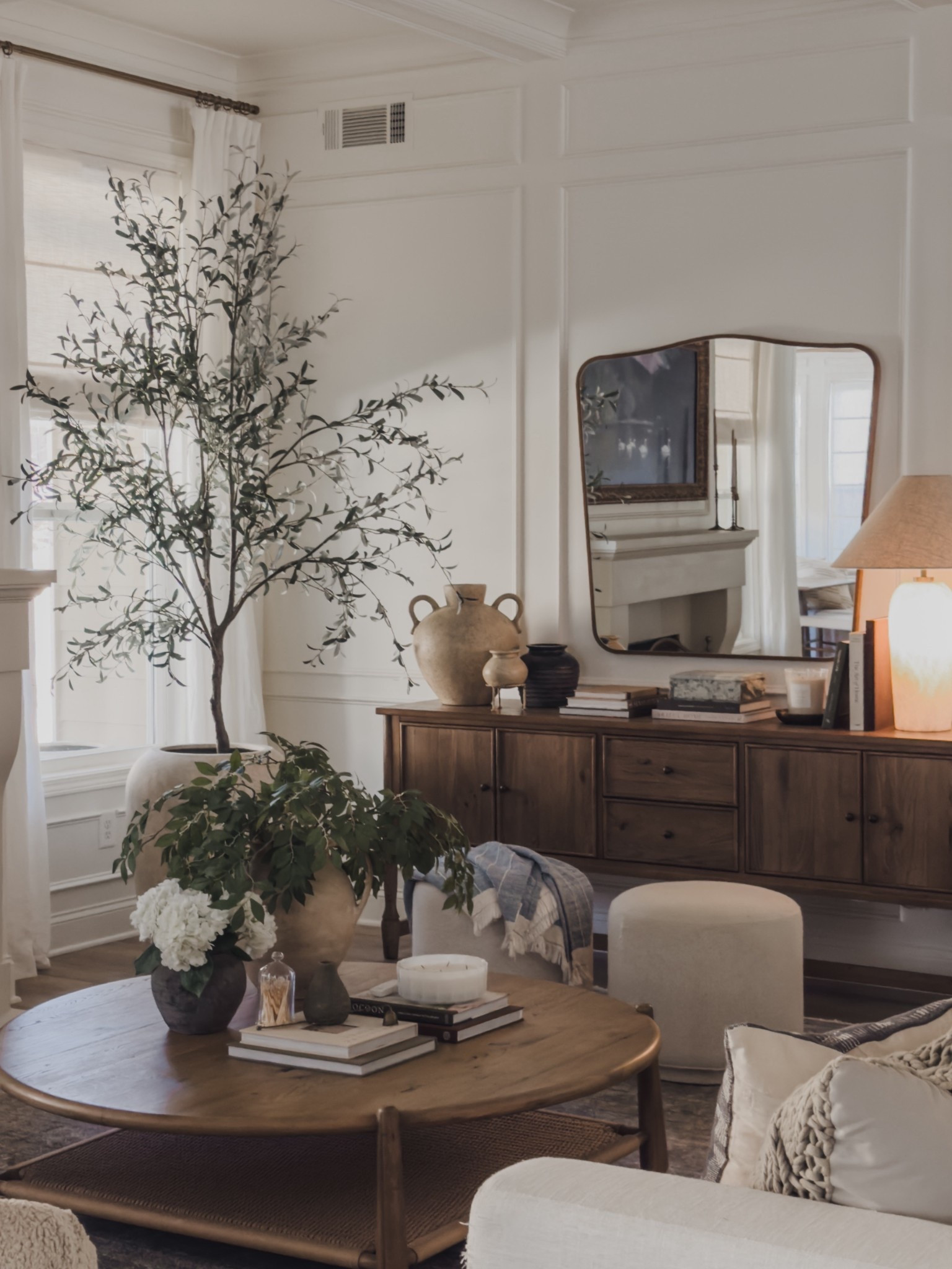 One of my favorite details of my sideboard is this stunning lamp - the alabaster detail illuminates at the base and gives the perfect glow, elevating any cozy vibe.

Home finds, neutral home inspo, living room views, neutral wood tones, furniture favorites, sideboard details, round coffee table, faux florals, collected style, oversized mirror, table lamp, neutral decor book, faux olive green, linen curtain, roman shades, ottoman faves, oversized planter, Four Hands, Pottery Barn style, Two Pages, Wayfair, Loloi, Amber Lewis, shop the look!

#LTKSeasonal #LTKHome