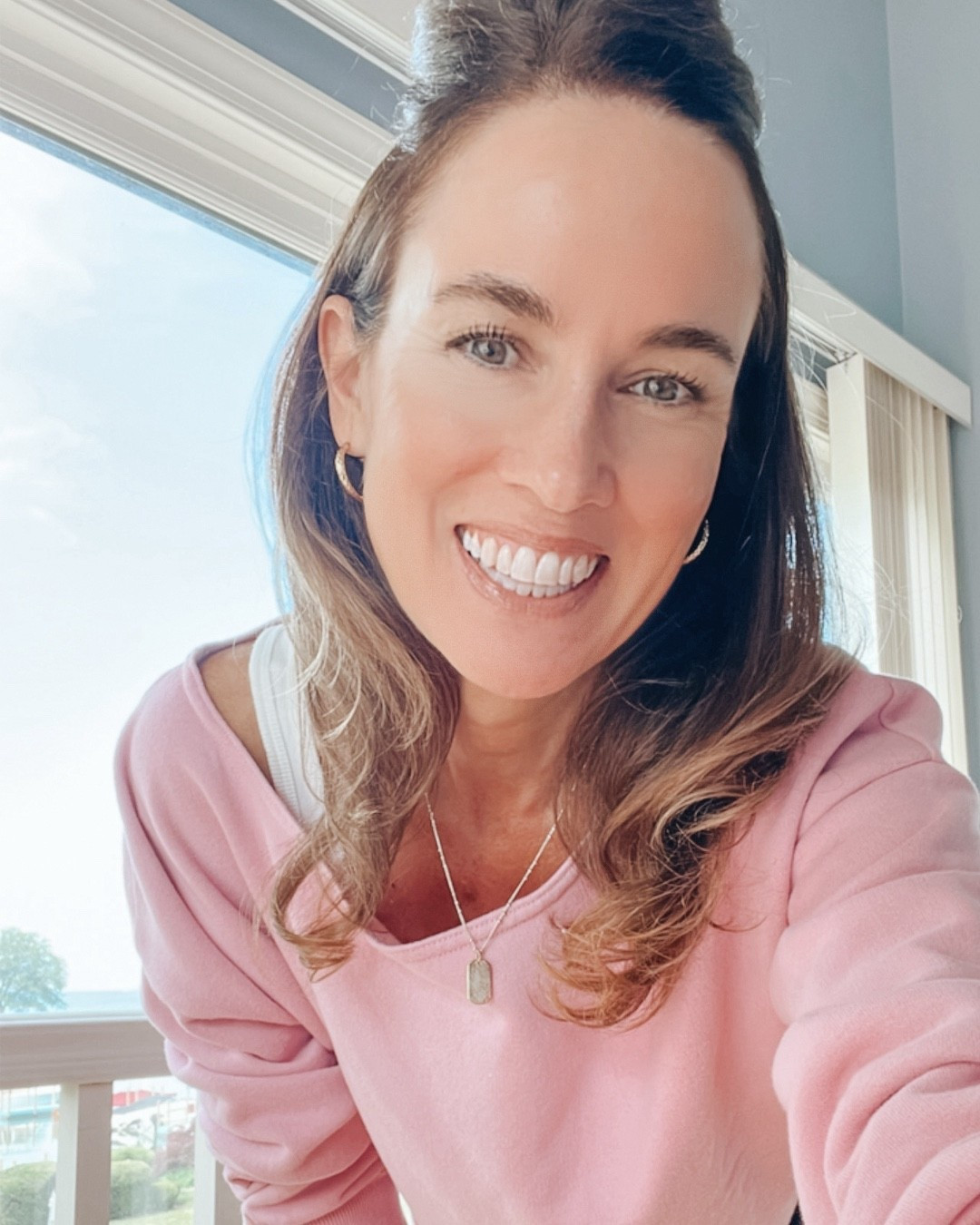 A cool summer day outfit "fit check" look.  Off the shoulder pink Hollister sweatshirt with white Hanes tank top and Agolde high rise straight grey jeans with Nike white sneakers. Gorjana dog tag silver necklace and gold hoop earrings.  #over50style #pinksweatshirt #nike #oldnavy #gorjana #hollister #summerstyle #fitcheck


#LTKOver40 #LTKFindsUnder50 #LTKSaleAlert
