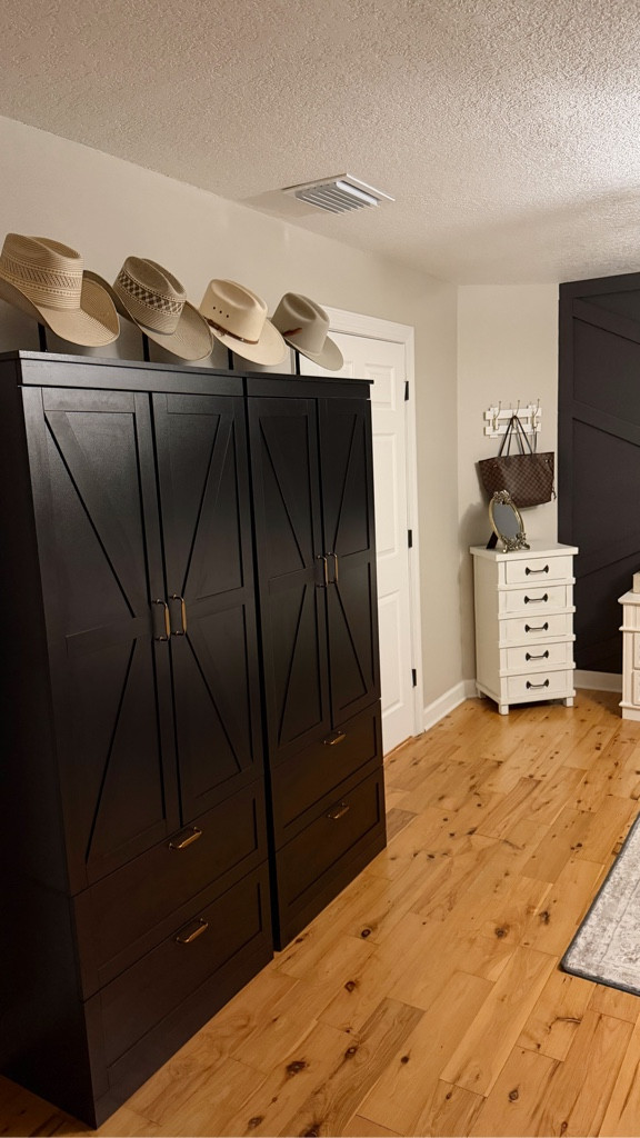 Main bedroom update! The goal was cottage farmhouse with western and antique touches in the decor. I linked the vintage style washable area rug, black metal bed frame, vintage cottage style floral bed set and quilt, black wardrobes we are using for clothing storage as well as the brass cabinet pulls we added to them, the stands we used for the cowboy hat display, gold antique style photo frames, jewelry display, stone horse head bookends, white bedroom nightstands with charging ports under $200 each, brass/gold curtain rods and dark gray black out curtains, brass/gold outlet and light switch covers, hanging wall decor, black wicker laundry basket, and antique style table lamps. Most items are from Amazon or Target!

#LTKHome #LTKFindsUnder50 #LTKFindsUnder100