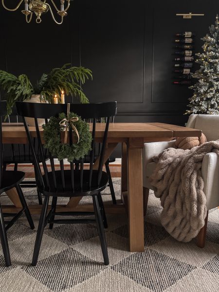 Moody Christmas dining room decor. 🎄

Accent wall: Sherwin Williams Black Magic
Table:  Leona Extension table from World Market in Light Graywash

Dining room, dining table, kitchen table, world market, farmhouse, modern, transitional, checkered rug, Chris loves Julia rug, wool rug, Loloi rug, wine rack, wine bar, picture lights, fall decor, fall stems, black dining chairs #LTKHoliday

#LTKhome #LTKSeasonal