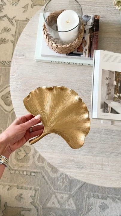 Accessorize your coffee table with this delicate gold leaf tray. 

Coffee table decor, neutral living room, coffee table books, glass hurricane candle holder

#LTKSeasonal #LTKU #LTKHome