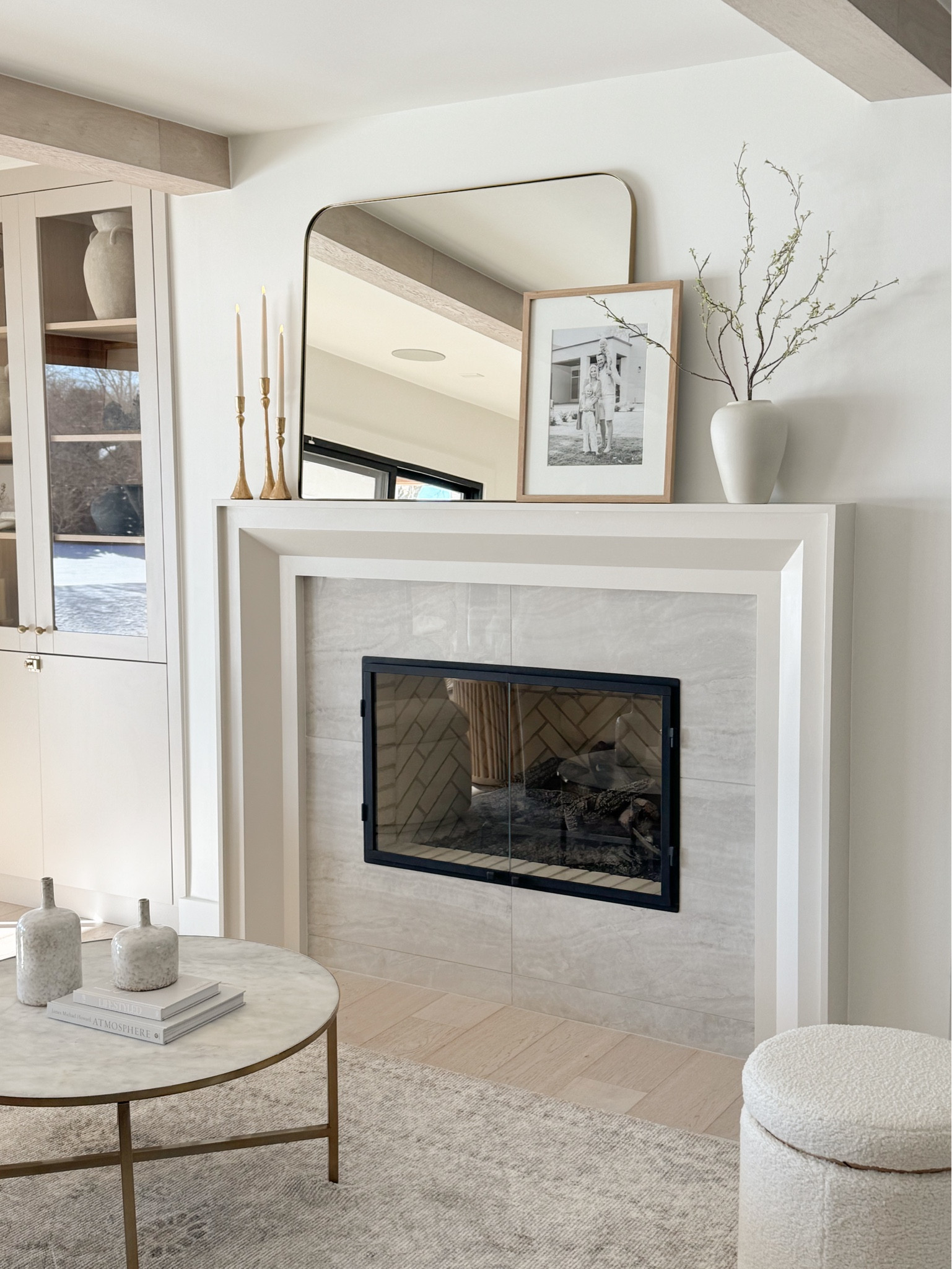 Style your mantel with a balance of elegance and simplicity using gold candlesticks, a sleek mirror, and natural accents. This cozy yet refined living room setup brings a timeless charm to any space.

#LTKHome #LTKStyleTip #LTKFindsUnder100