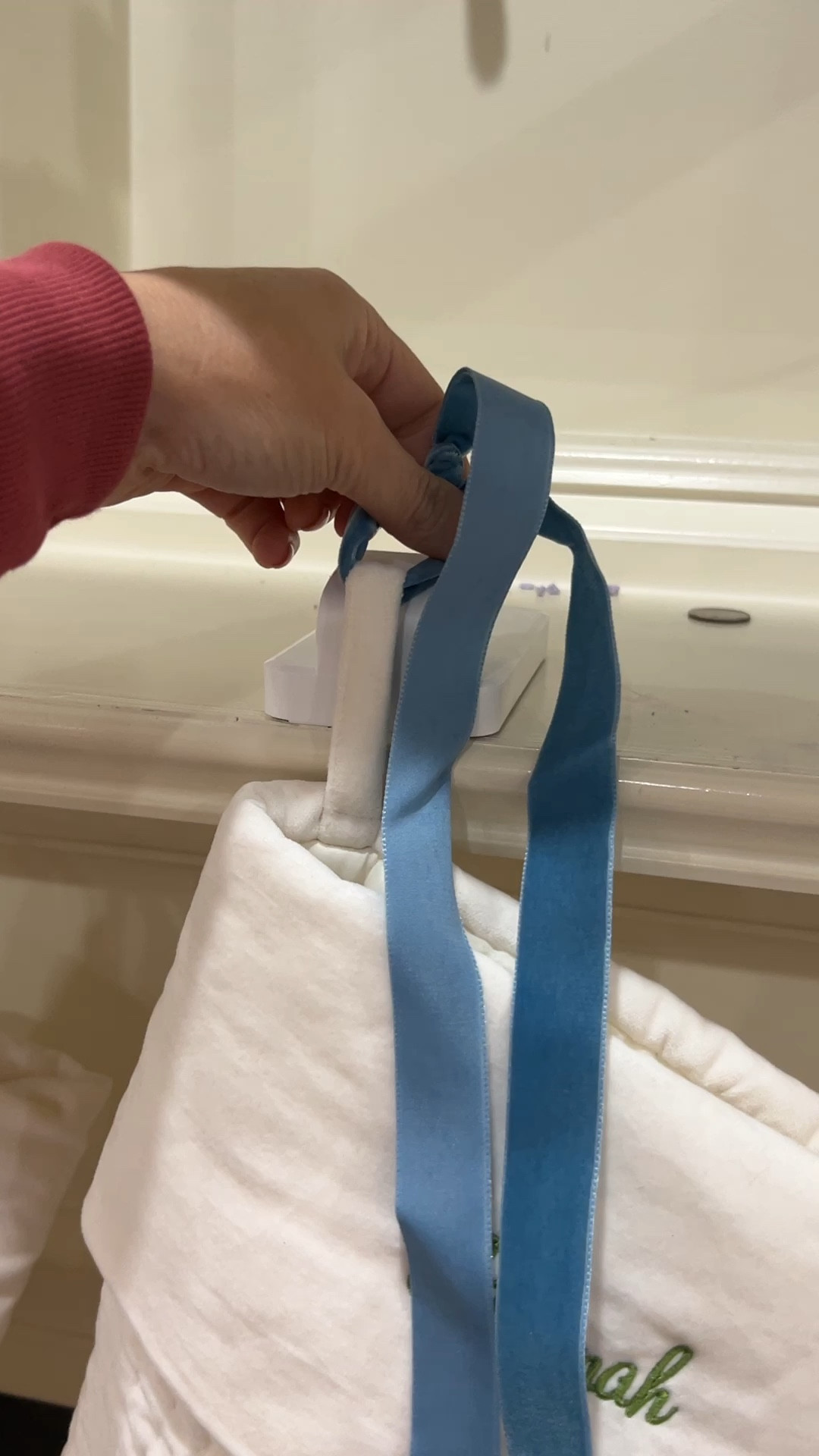 We have the large stockings and I use the Williamsburg blue velvet ribbon to extend where the stocking hangs. Then I hide the hooks with garland. 

#LTKHome #LTKSeasonal #LTKHoliday