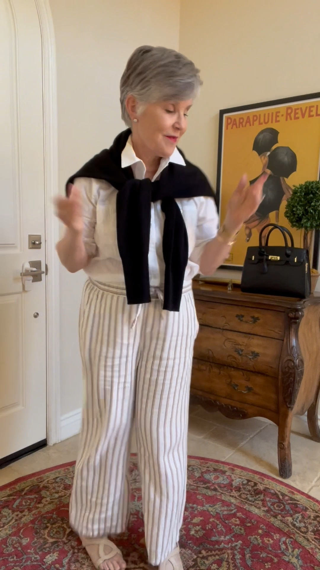 f you think a neutral outfit is too boring, watch this! PLEASE FOLLOE ME ⬇️ FOR MORE! Take a white shirt and white striped linen pants with tan sandals and make it MUCH more interesting by ADDING ACCESSORIES! Yup, just do this: roll up your sleeves (elevates the look), add a gold watch, bracelet, diamond (or zirconium studs) to look classy. Add a black cashmere sweater around your neck (also a neutral) and match it to this terrifically priced @amazonfashion black bag. Finish your NOW ANYTHING BUT BORING, neutral look!

#LTKStyleTip #LTKWatchNow #LTKOver40
