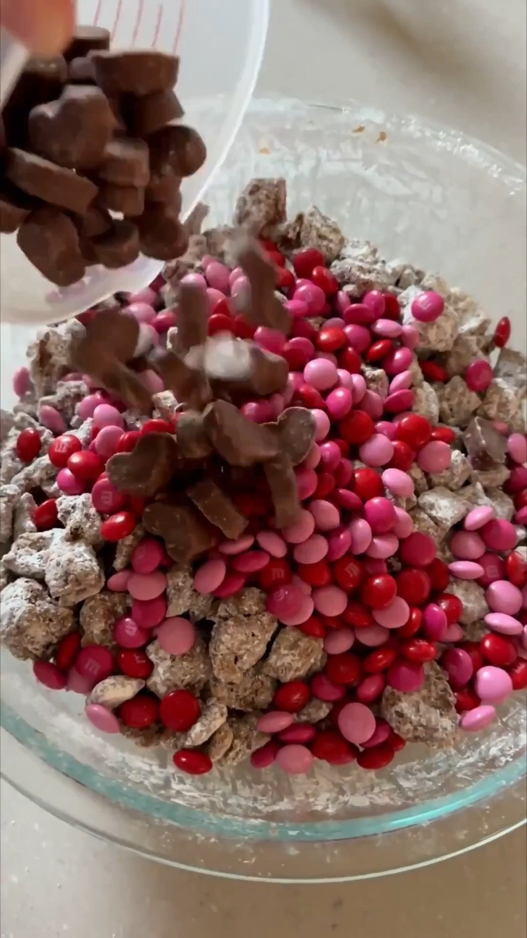 The reindeer food was such a hit, I put a little twist on it and we have cupid’s food 💘 Put it in a fancy little jar and makes a perfect gift 🎁 

Recipe
• 1 ½ cups semisweet or dark chocolate chips
• 1 ½ cups creamy peanut butter
• 5 cups Rice Chex Cereal
• 1 ½ cups mini pretzels broken into pieces
• 2 cups powdered sugar
• 1 ½ cups of pink & red M&Ms
• 1 cup mini heart shaped peanut butter cups

In a large bowl, combine rice Chex cereal and pretzel pieces.
Melt peanut butter and chocolate together, either on the stovetop or in the microwave.
Pour peanut butter chocolate mixture over cereal/pretzel mixture and stir to combine.
Chill in the refrigerator until the mixture just barely begins to set up (about 30 minutes).
Remove the mixture from the refrigerator.
In a separate, large bowl, put ½ cup powdered sugar on the bottom of the bowl. Add half of the chilled mixture, then add another ½ cup powdered sugar over the cereal and the remaining chocolate/cereal mixture.
Gently stir until the powdered sugar is evenly distributed, tossing to coat the cereal with powdered sugar.
Chill the mixture again in the refrigerator until it’s set (about another 30-60 minutes).
Add more powdered sugar, ¼ cup at a time until the cereal/pretzel mixture is coated.
Add M&Ms and peanut butter cups and stir to combine.
Transfer to a serving bowl and serve.

Amazon, Target, Valentines Day treat, Valentines Day gift, Valentines day party, reindeer food, Cupid’s food, seasonal treat, kids snack

#LTKValentine #LTKfoodie #LTKmomlife