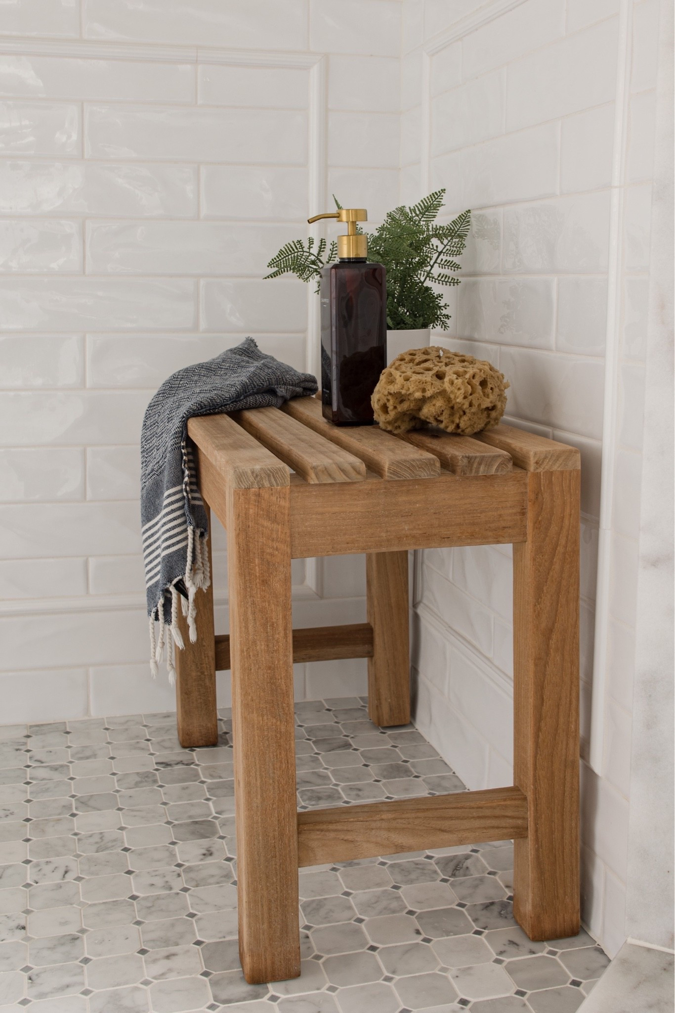 Teak shower bench in shower with marble tile floors

#LTKSeasonal #LTKHome