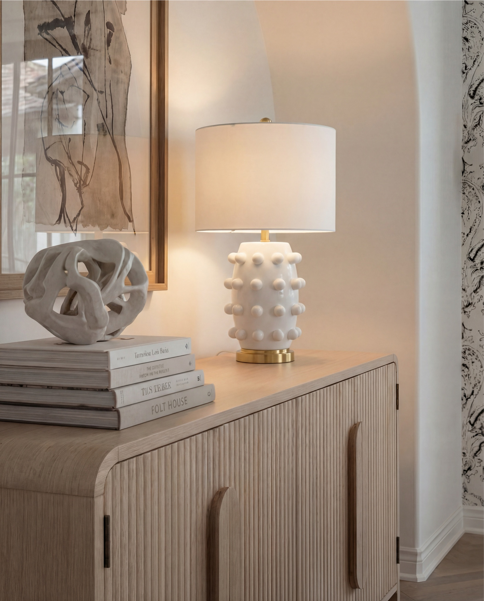 Round wood dining table, wood weave dining chairs, oak console buffet, beige traditional rug, black vase, white table lamp. Brass tray, candle holder brass.  

#LTKHome #LTKSaleAlert