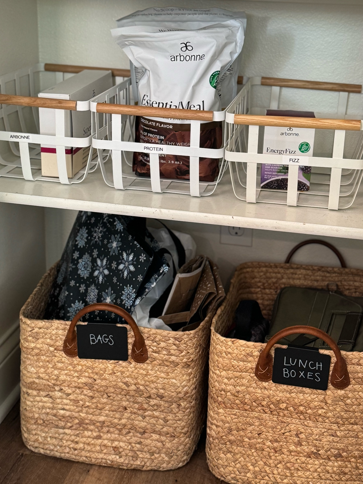 White baskets, large brown storage baskets, and label maker 