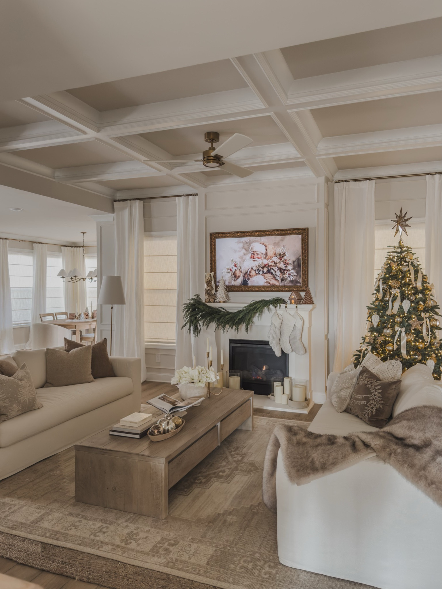 Cozy Pottery Barn style Christmas views! Loving the neutral and warming vibes from seasonal greenery, cozy frame art, and neutral wood tones

Home finds, cozy Christmas vibes, living room refresh, upholstered sofa, neutral stockings, coffee table book, frame tv, faux fur blanket, mercury ornament, garland faves, Pottery Barn style, coffee table decor, linen curtain, gold detail, Christmas tree, marble book stand, faux florals, neutral ornaments, found it on Amazon, candelabra, neutral decor, neutral Christmas inso, shop the look!