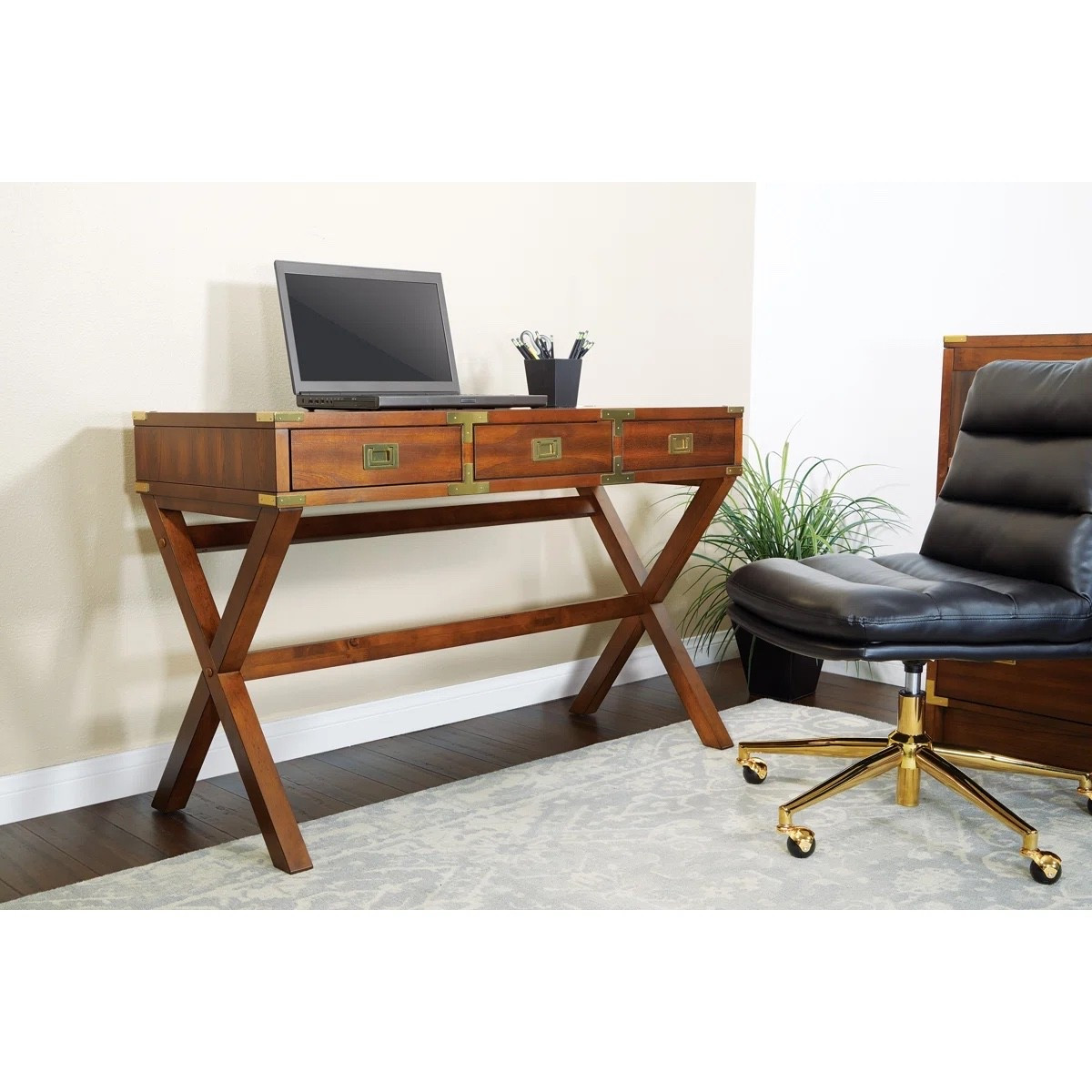 This solid wood writing desk from Wayfair is the perfect blend of classic style and everyday function ✨🪑 Featuring a rich wood finish, brass hardware, and built-in power outlet, it’s ideal for creating a stylish and practical workspace at home. Styled with a laptop, desk accessories, and a leather office chair for a warm, elevated office look. 
