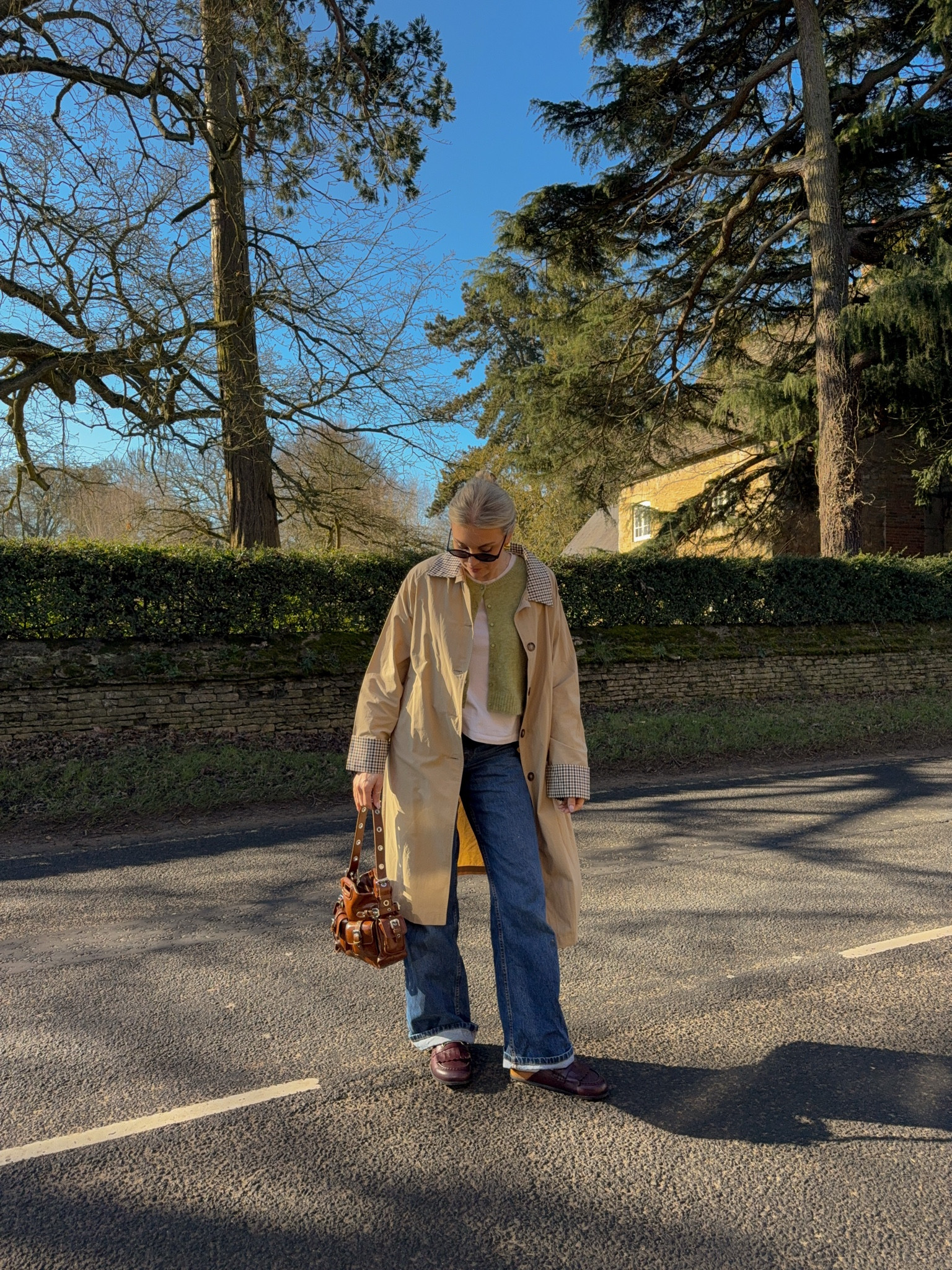 Spring outfit inspo - checked trench coat from boohoo, sezane dark wash wide leg jeans, Russell and Bromley leather slip on clogs, sezane green cardigan, maje buckle shoulder bag, Amazon black slim sunglasses 

#LTKSeasonal #LTKeurope #LTKstyletip