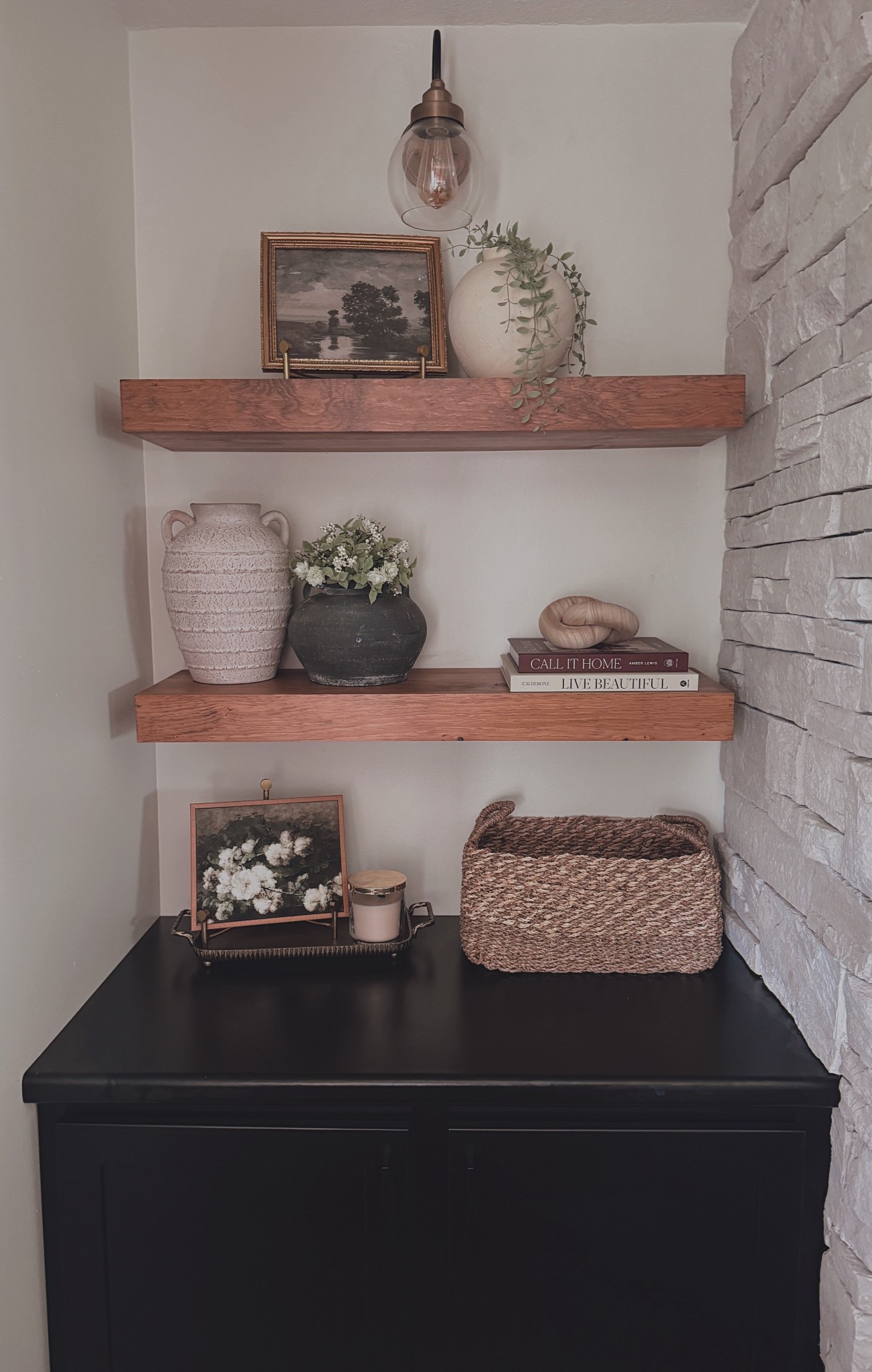 Cozy, curated shelf styling 🤍 This corner nook combines warm wood floating shelves, textured pottery, vintage art prints, and layered greenery for a timeless, collected look. I’ve linked every detail so you can easily recreate this neutral, cozy aesthetic in your own home!

#ShelfStyling #FloatingShelves #NeutralHomeDecor #HomeDecorInspo #ShelfDecor #CozyHomeVibes #CollectedHome #ModernFarmhouseDecor #VintageInspired #HomeDecorFinds #LTKHome #LTKDecor #LTKUnder50 #LTKSaleAlert