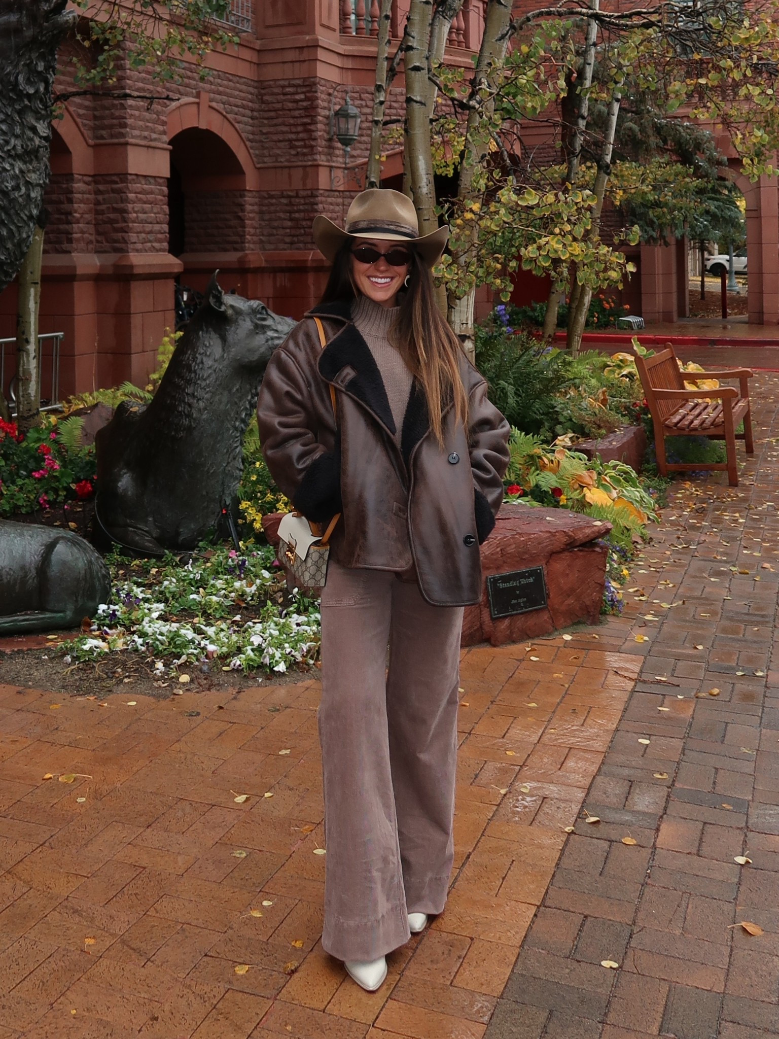 winter western outfit in Aspen 🤠

Brown leather jacket with black fur trim- size 0 (so cozy the perfect fall/winter coat)
Mock neck turtleneck sweater- size XS (rolled up the bottom to make it cropped)
Tan corduroy pants- size 26 (got them hemmed and probably could’ve done a 25)
Brown western belt- XS

Linked similar cream cowboy boots and brown cowboy rancher hats. 
The same Gucci crossbody bagis being sold on the real real and doubles as the cutest handheld bag- linked a similar style one from Rebecca Minkoff that makes for such a cute fall bag