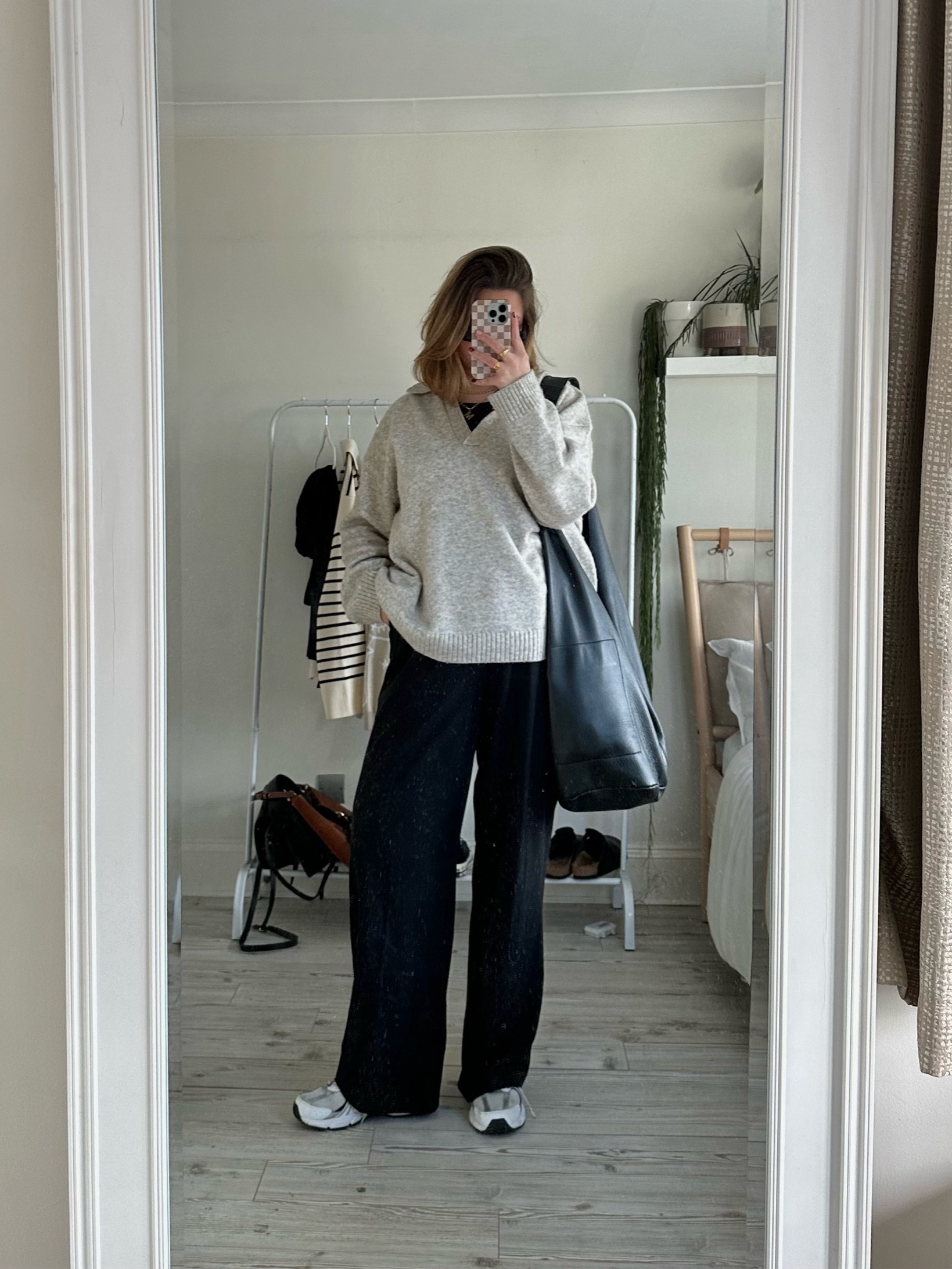 Go to outfit for work featuring black wide leg trousers, Uniqlo bra top, beige v neck jumper, new balance trainers and leather tote bag. 

#LTKworkwear