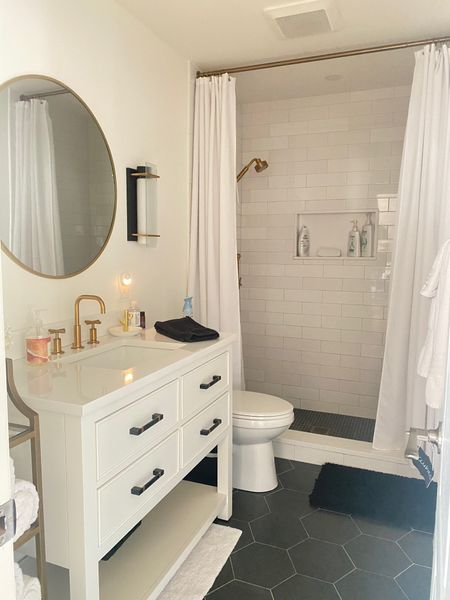 Update your bathroom with a white vanity, gold round mirror, and updated wall sconces  

#LTKhome #LTKstyletip #LTKFind