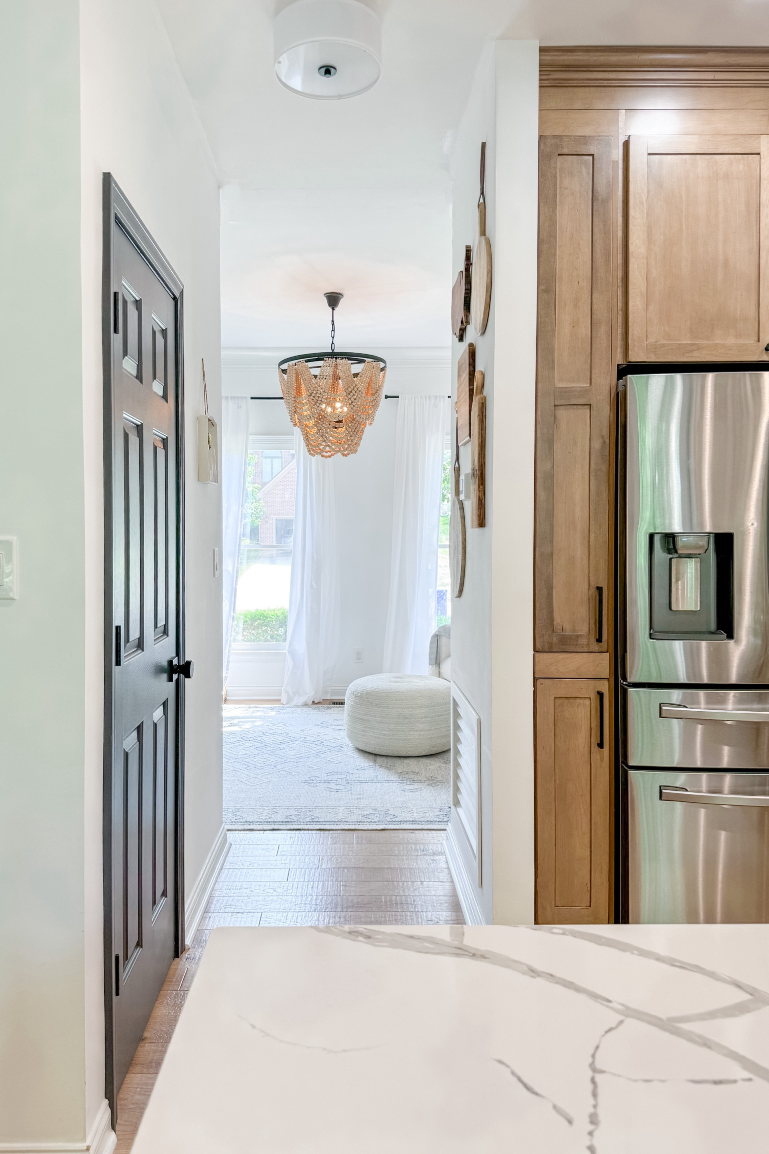 Door color: Cracked Pepper
Wall color: Chantilly Lace
Quartz counters: from a local supplier
Cabinets: husk stain on maple wood in Ellery Style (linked)
Flooring: linked
Chandelier: I spray painted the metal black with rustoleum spray paint


#LTKhome
