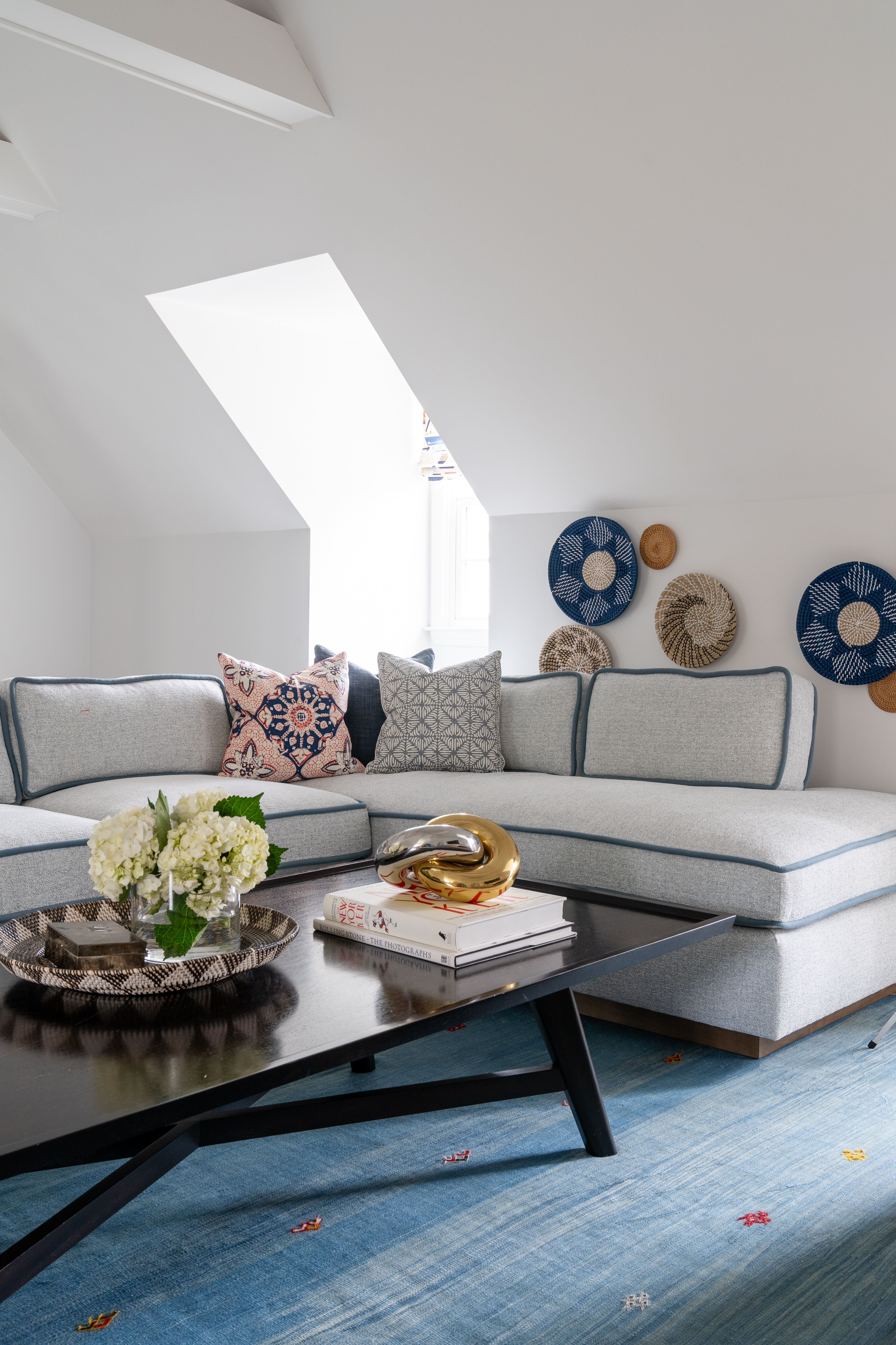 Talk about a cool, coastal living room! This space is elevated with a cozy sectional, colorful throw pillows, unique wall art, and coffee table decor. A true oasis in a waterfront home! 

 

#LTKFamily #LTKHome #LTKStyleTip