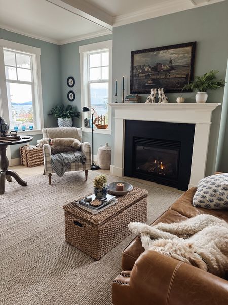 Living room sources - jute rug, leather chair, plaid chair, woven lidded trunk, black round wall art, wingback chair, blue and white planter, throw blankets and pillows 

#LTKstyletip #LTKSeasonal #LTKhome