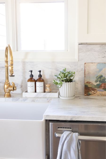 Kitchen decor with marble countertops, scalloped planter, target home decor, brass faucet 

#LTKhome #LTKSeasonal