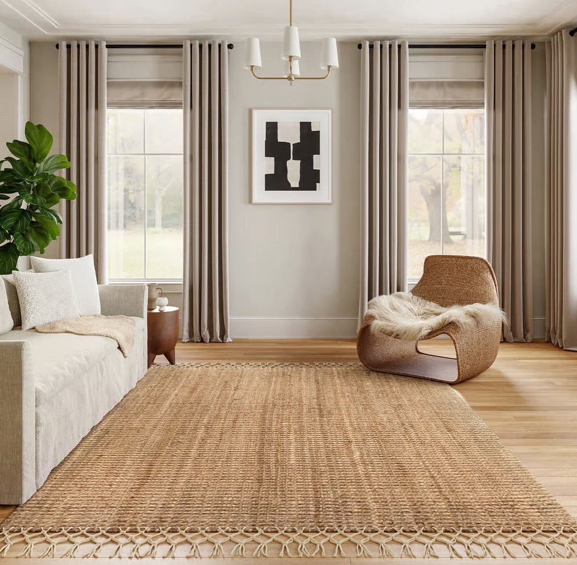 This chunky woven jute rug is the star of the space, bringing warmth and natural texture to the whole room. Styled with a soft neutral sofa and a sculptural accent chair for that calm, organic modern look. All pieces work beautifully together for an inviting, earthy living room. #homedecor #neutralstyle #livingroominspo #naturalmaterials