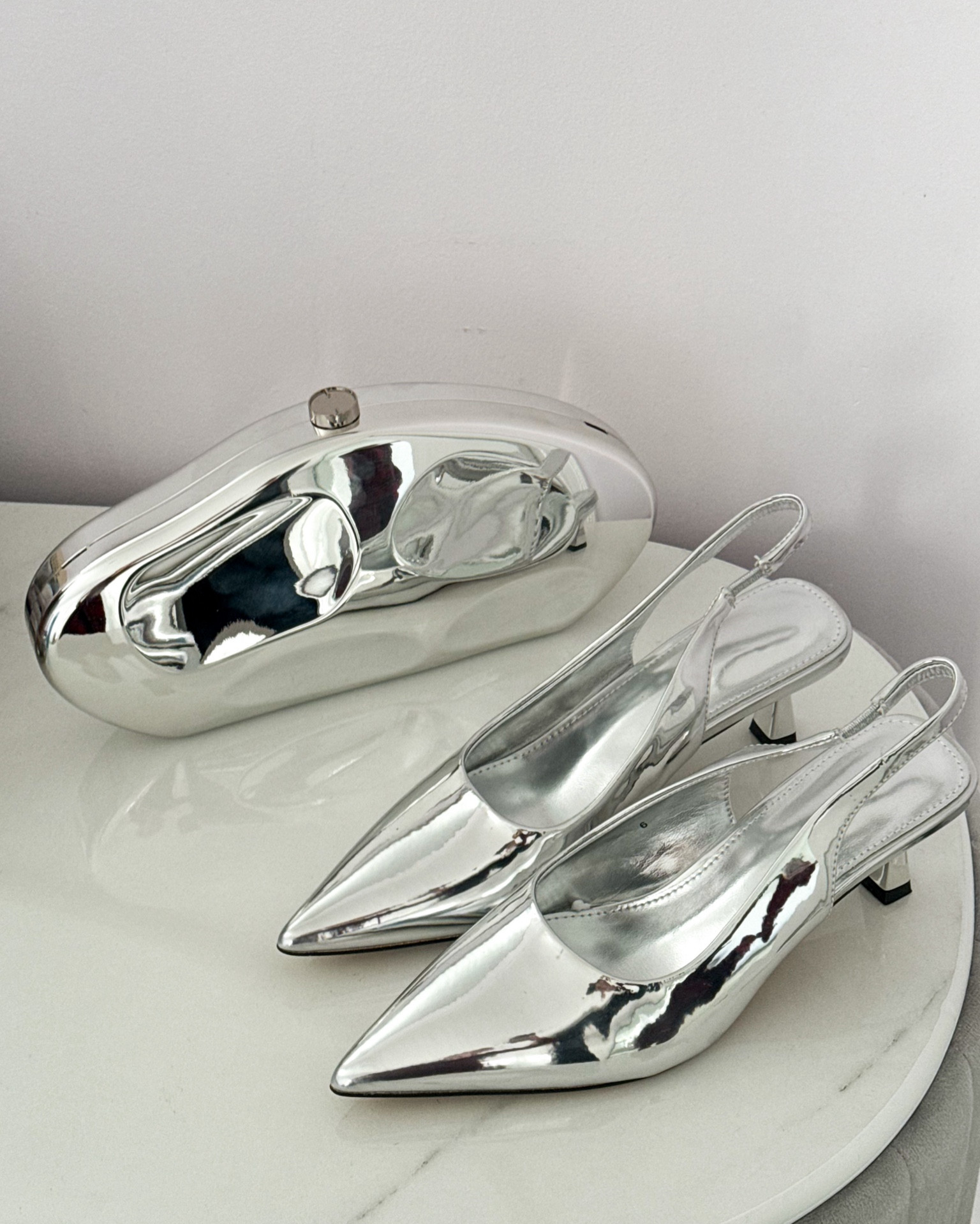 Add a touch of sparkle to any outfit ✨ These silver slingback heels and metallic clutch bag are the perfect accessories for holiday parties, weddings, or a glam night out. Effortlessly elevate your look with these must-have pieces!
.
.
.
.
.
.
.
.
#LTKCyberWeek 
#LTKSeasonal #LTKHoliday #LTKU #LTKSaleAlert #LTKGiftGuide #LTKWorkwear #LTKShoeCrush #LTKItBag 

Silver heels | holiday heels | metallic heels | silver heels | comfortable heels | closed toe heels | clutch purse | clutch bag | silver clutch | evening clutch | holiday clutch | 

#LTKFindsUnder100 #LTKStyleTip #LTKFindsUnder50