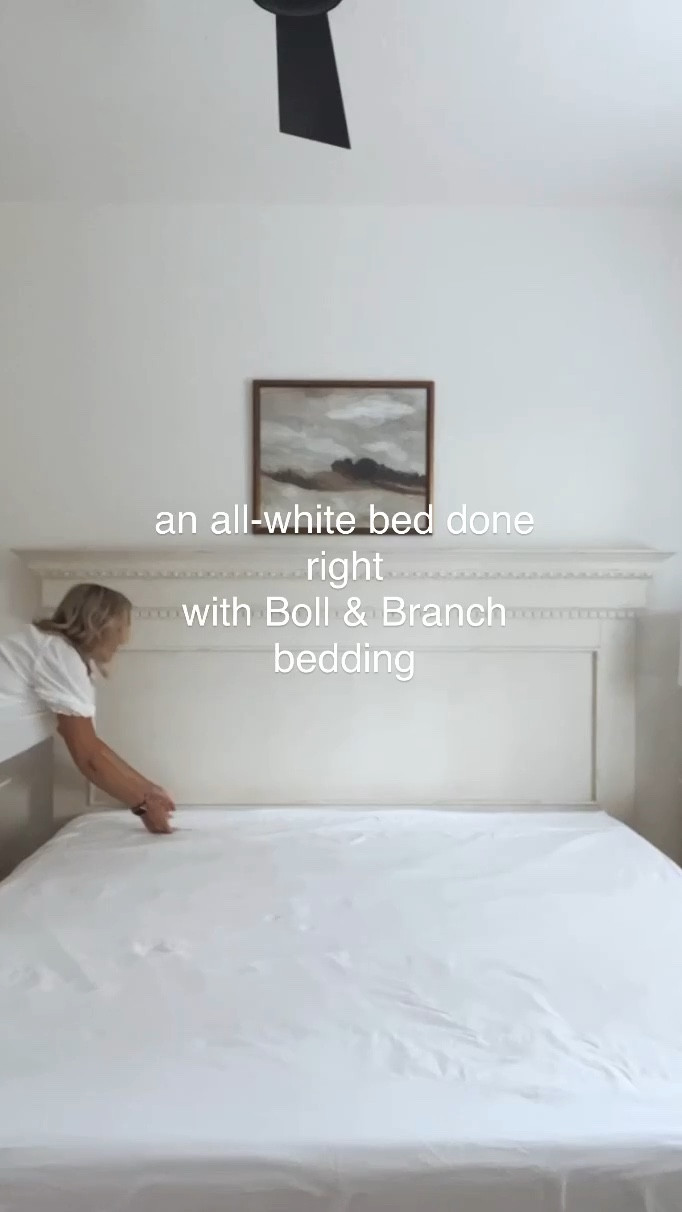 My primary bedroom has Boll and Branch white bedding including a sheet set, waffle bed blanket, duvet cover and pillow shams  