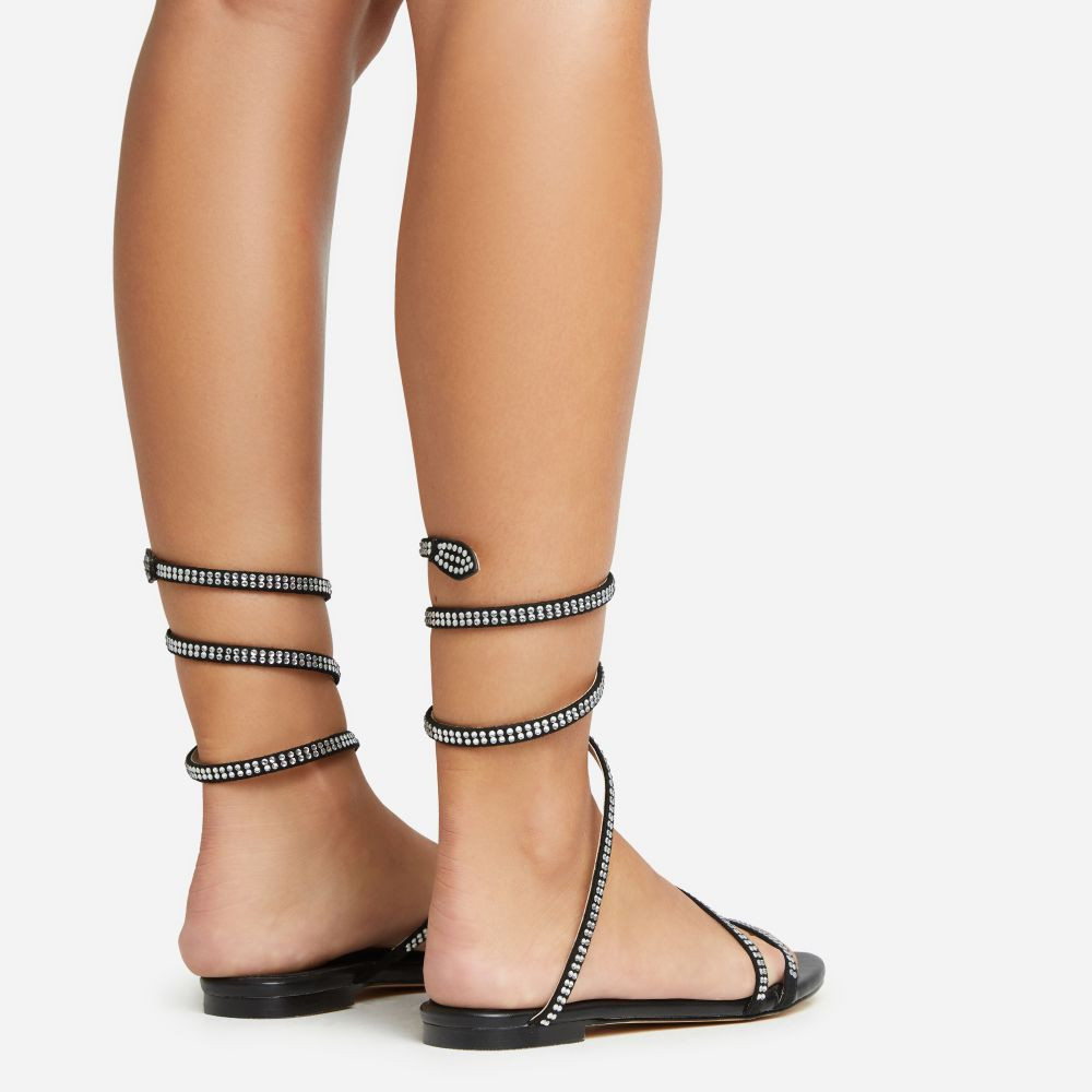 Maribelle Diamante Wrap Around Strap Detail Flat Sandal In Black Faux Leather | EGO (UK)