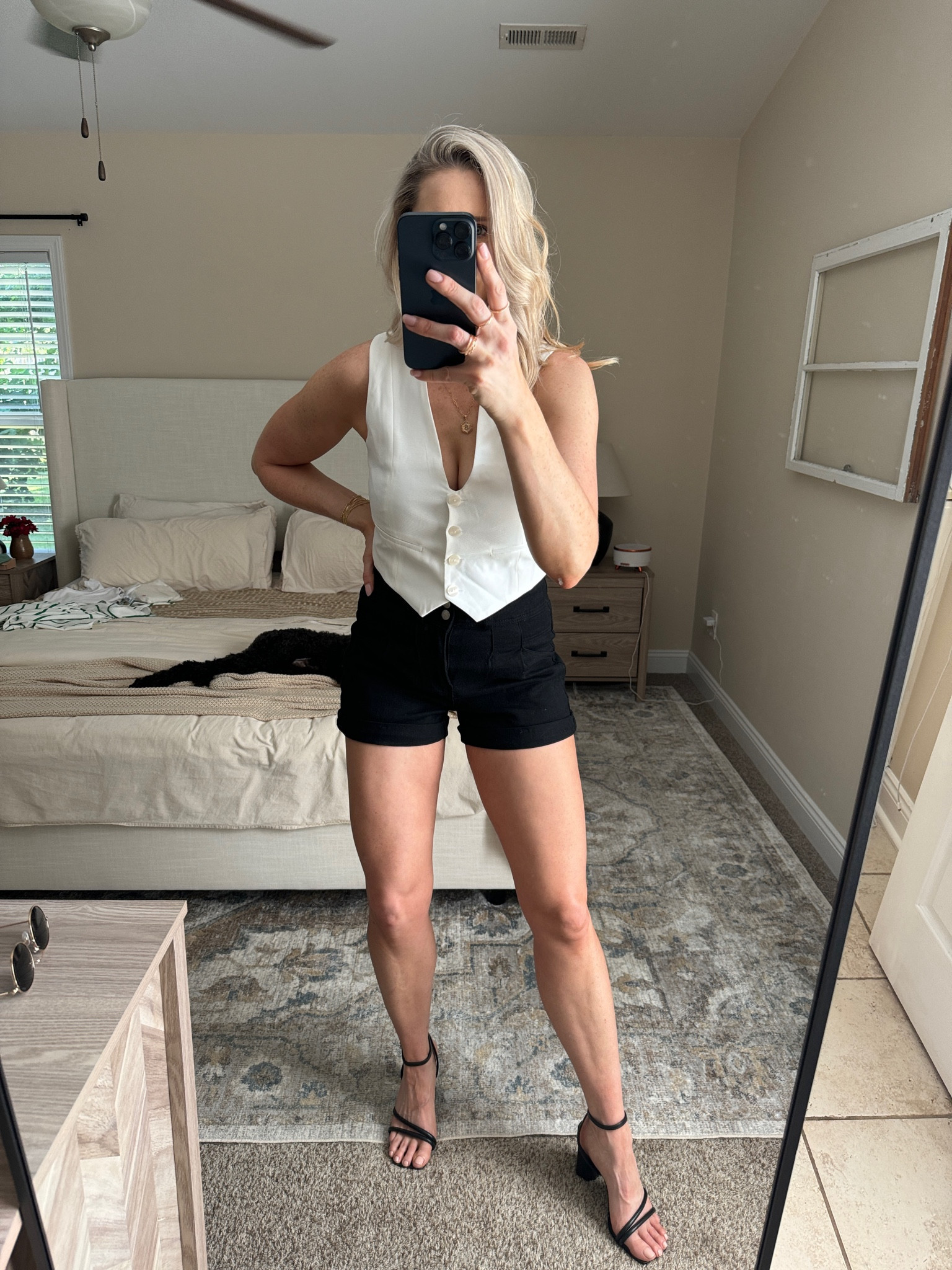 Black denim shorts, white vest and black heels 