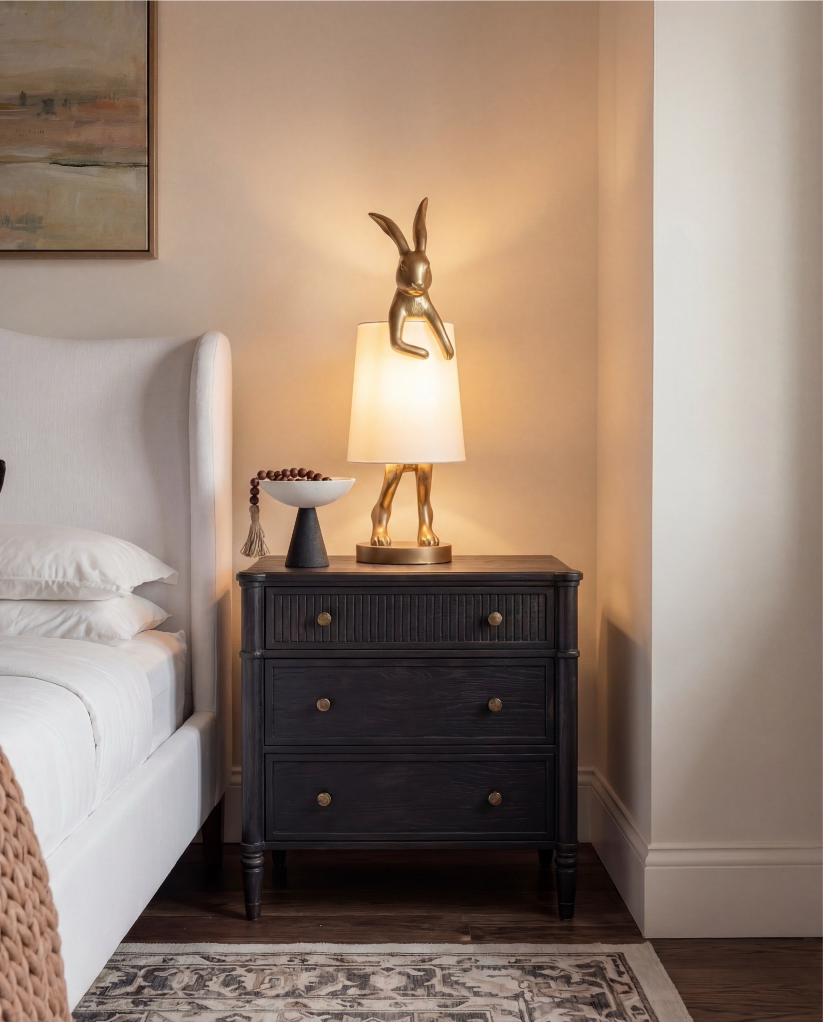 Shop the Look: Bedroom Refresh
• Upholstered wingback bed (ivory fabric)
• White cotton bedding set
• Neutral euro pillows
• Black and tan patterned accent pillows
• Chunky knit throw blanket (camel brown)
• Dark black wood nightstands
• Decorative bunny Brass table lamps with white shades
• Framed abstract wall art (neutral tones)
• Vintage-style area rug (beige and taupe)
• Dark black wood dresser with brass hardware
• Brass ring drawer pulls
• Glass hurricane candle holders
• White pillar candles
• Decorative brass tray
• Sculptural brass decor object
• Small stone sculpture 
• Light beige linen curtains
• Ceramic vase (off-white)
• Decorative branches
• Coffee table books (neutral covers)
• Upholstered bench at foot of bed (cream fabric)
•upholstered wood accent chair 
•round ribbed black end table 



#LTKSaleAlert #LTKHome