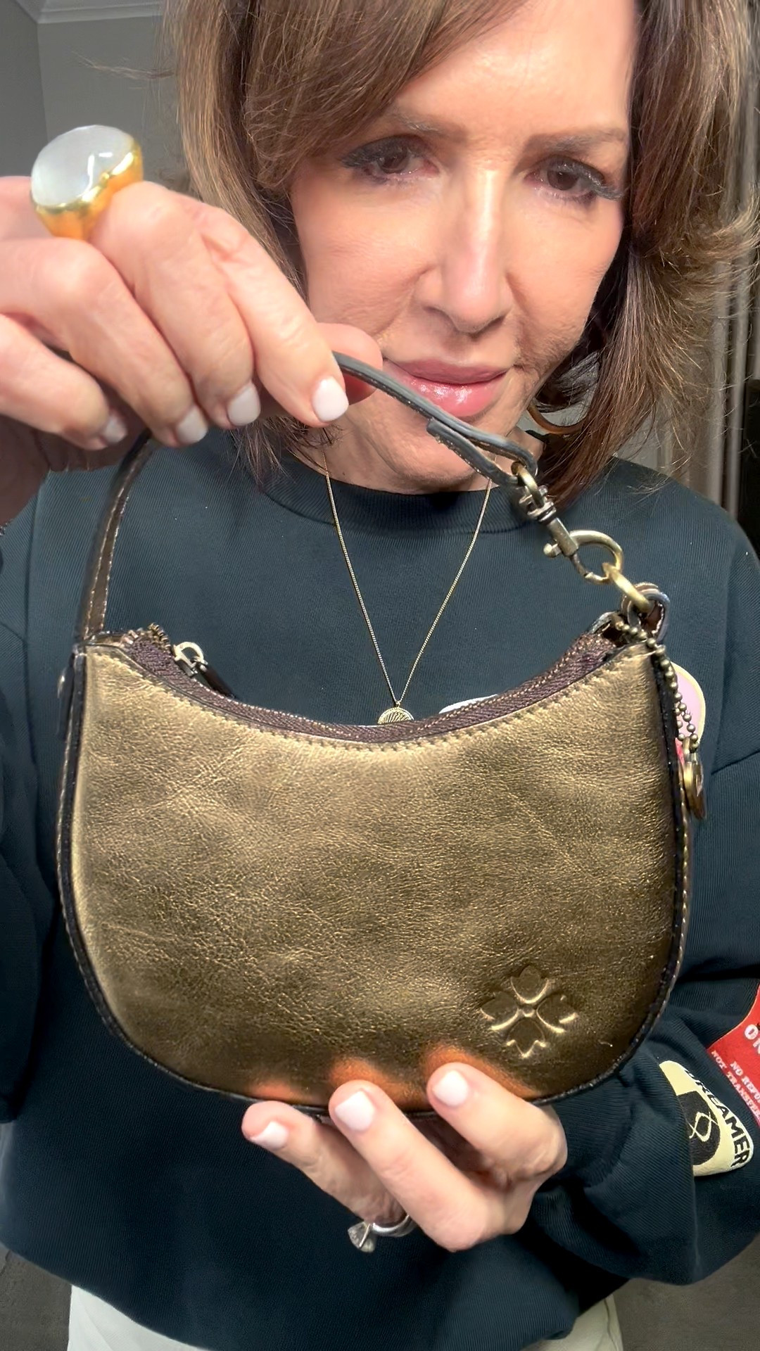 gold metallic handbag, gold necklace, graphic pullover 

#LTKootd #LTKOver40 #LTKSeasonal