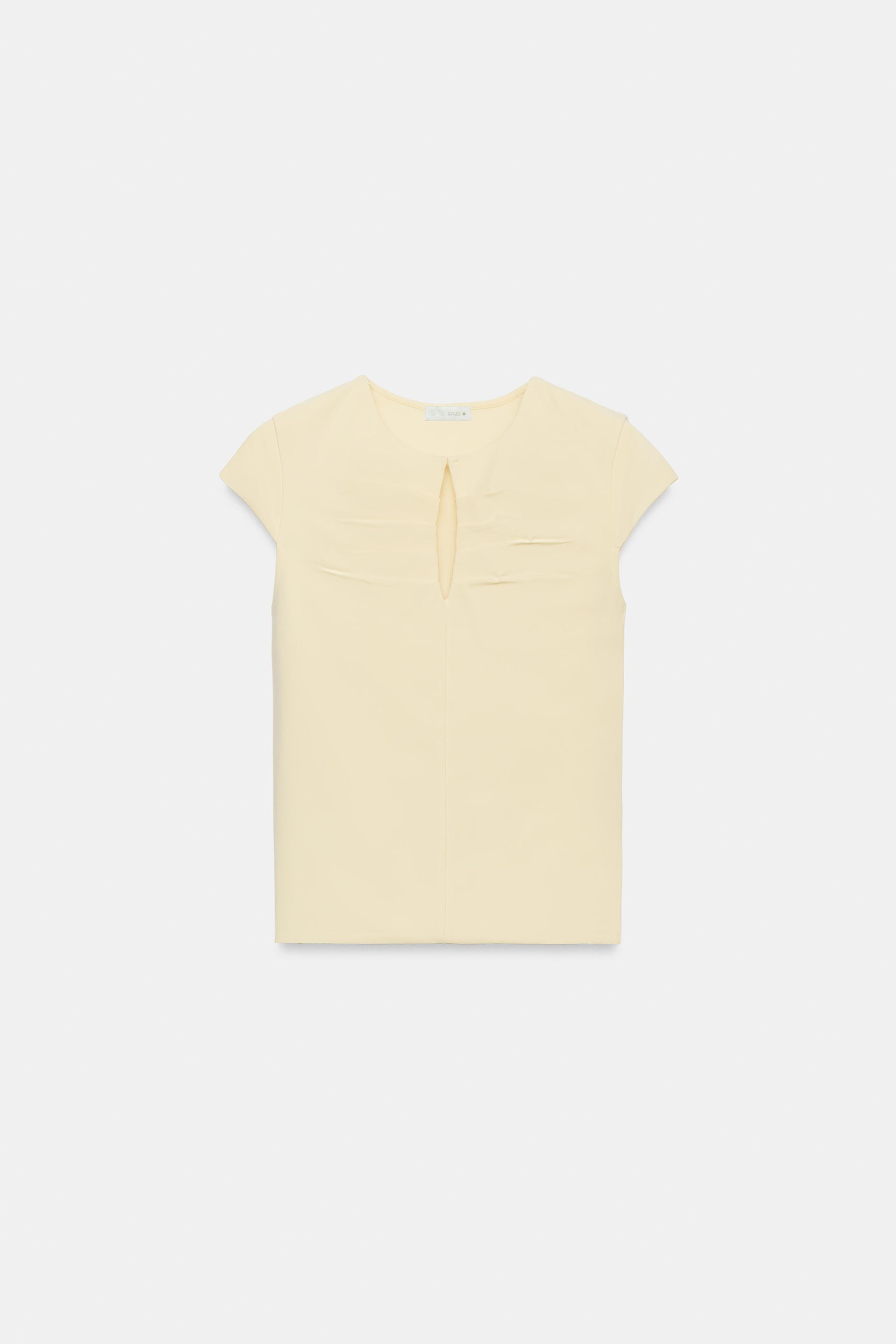 Top made of a 100% cotton blend fabric. Round neck with opening and very short sleeves. Pleated d... | Zara US