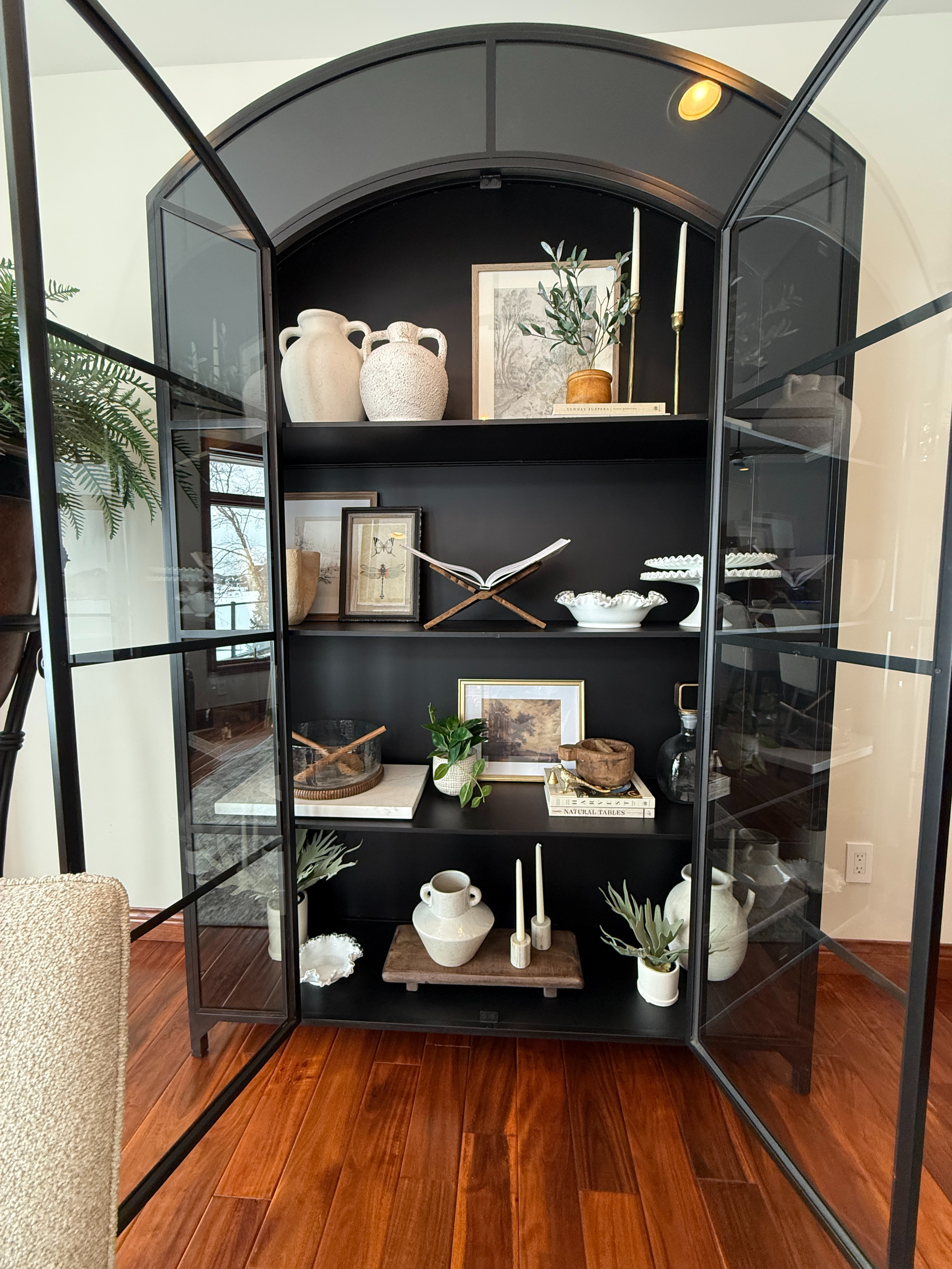We don't like to play favorites in any of our interior design projects, but we'd be lying if we said this display cabinet wasn't up there. 

A statement piece in itself, but also a practical way to store dishes, serveware, cookbooks, and in this case, family mementos. Situated between their eat-in area and kitchen for easy accessibility for hosting and glass doors that fully close to avoid unnecessary dusting. 

Truly a showstopper.  

 #LTKHome #LTKSaleAlert