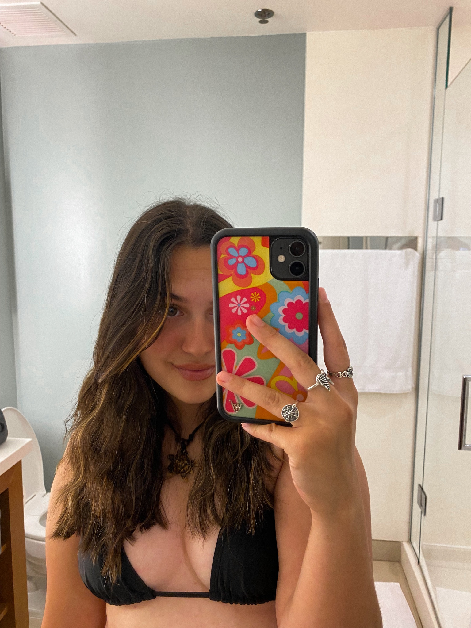 bathroom vaycay pic!! classic black triangle kini with colorful wildflower phone case 🫶🏼🌸 love the turtle necklace also!!! perfect essentials for summer 🤗

#LTKU #LTKfindsunder50 #LTKSeasonal