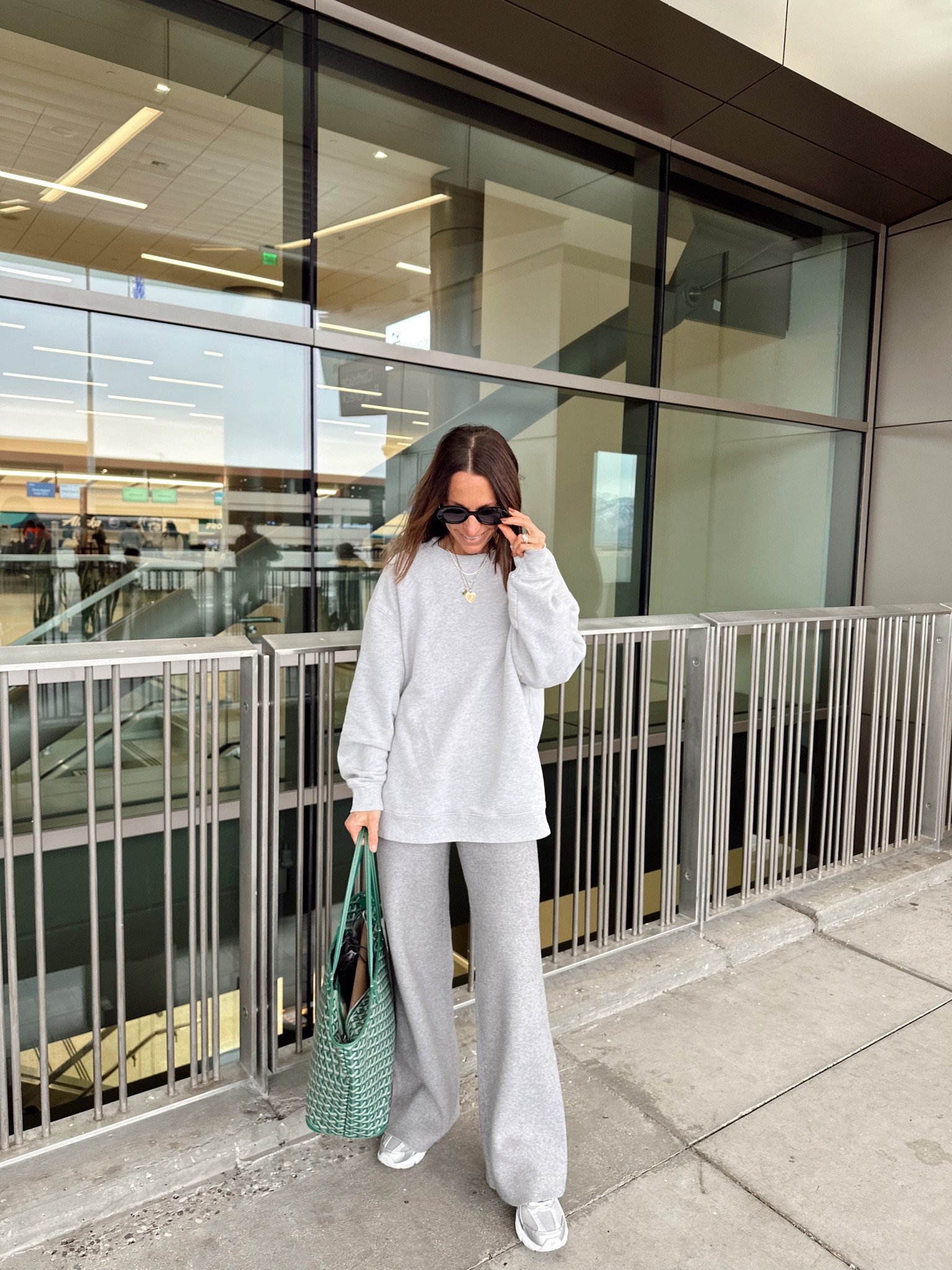 Today’s travel OUTIFT 
Oversized grey sweatshirt is 30% off and it’s my favorite 
Grey knit pants are 25% off- short gal friendly if you roll the waist over 
Silver and grey sneakers are 25% off too 

#LTKCyberWeek #LTKOver40