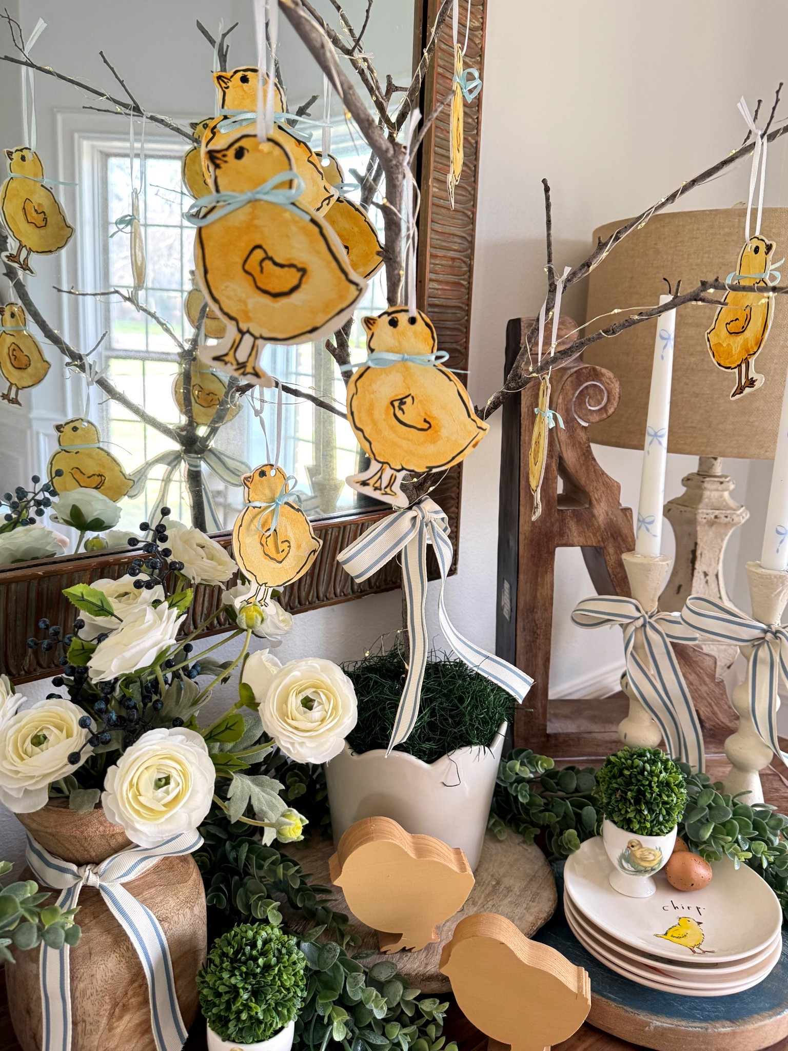 Prime and watercolor paint wood craft chicks. Then, use sharpie to add detail and outline. Tie with ribbon to hang or add bows  