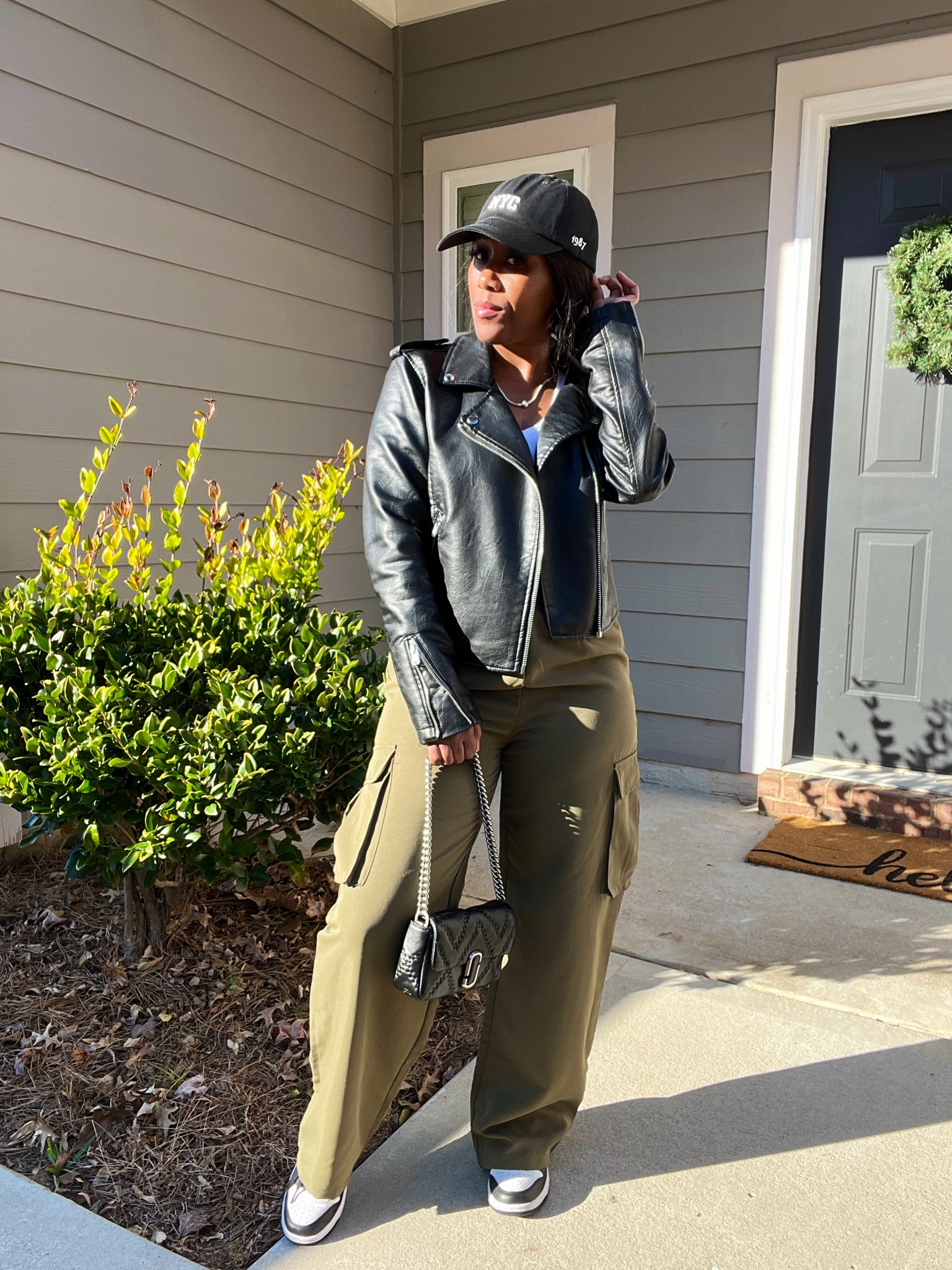 Black faux leather jacket, black hat, white crop top, black purse, army green wide leg cargo pants, and Nike dunk low panda sneakers

#LTKFindsUnder100 #LTKShoeCrush #LTKStyleTip