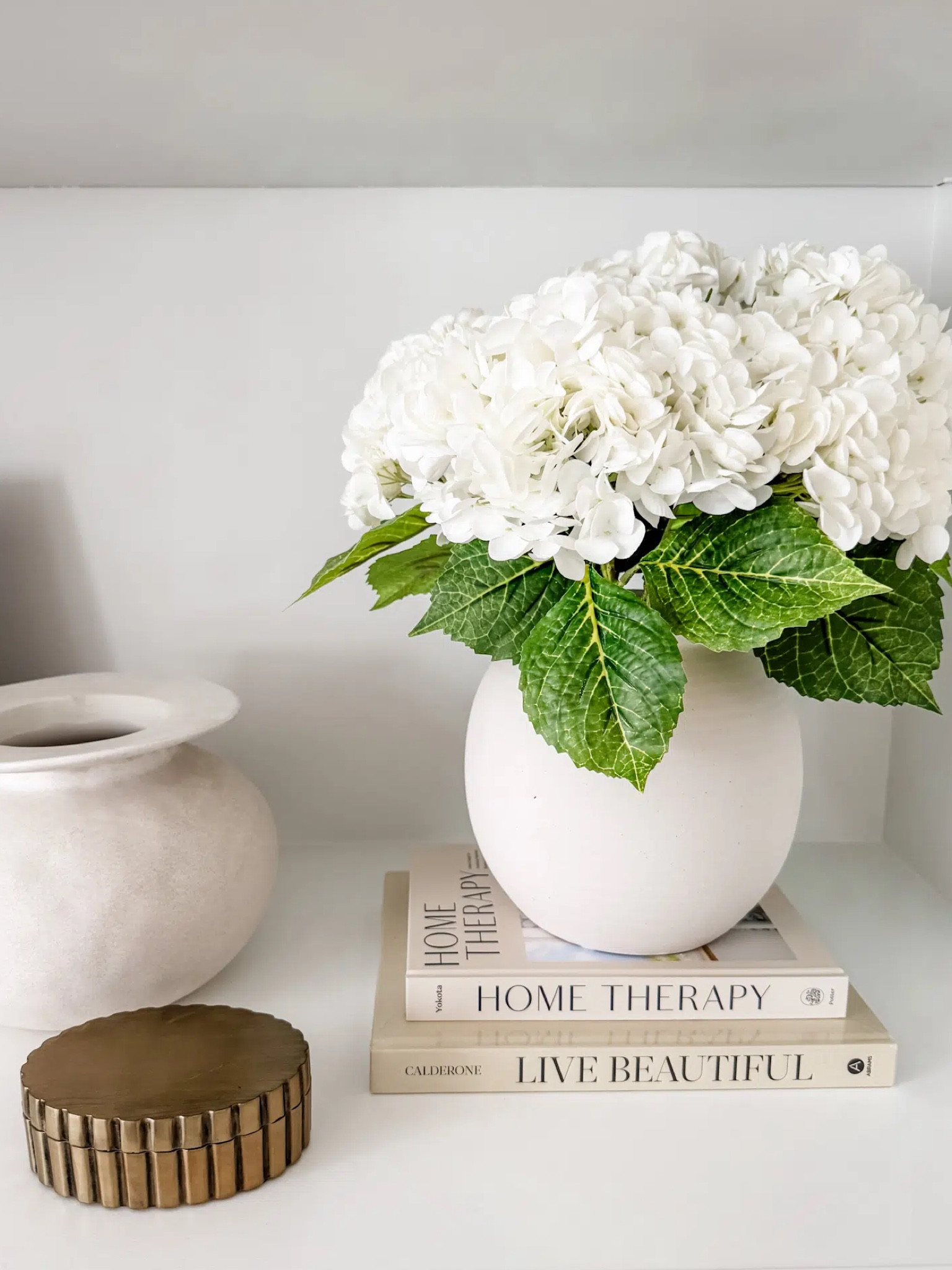 Real Touch Faux Hydrangea
Artificial hydrangea flowers
Faux Spring Florals
Faux flower stems
Spring Stems
Coffee table books
Ceramic vase
Console table decor


#LTKSeasonal #LTKStyleTip #LTKHome