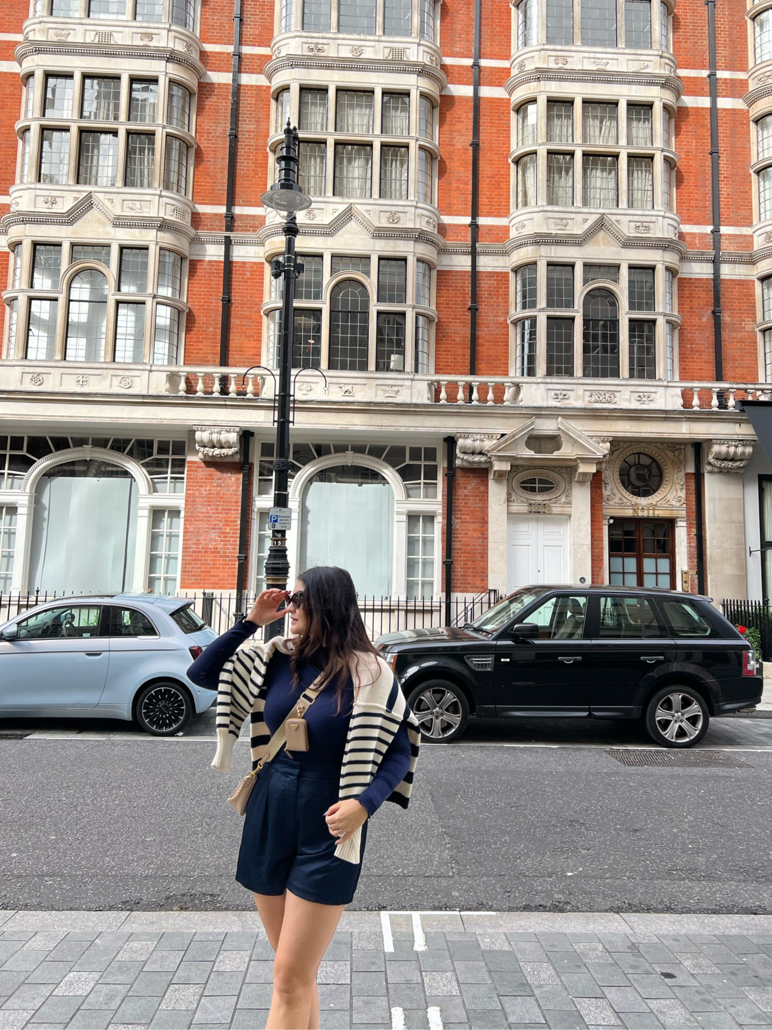 Casual chic outfit; my navy satin shorts are sold out but the black and cream are still available. Highly recommend those! 
London outfits 
Stain shorts 
Navy outfit  
Oversized Striped sweater 
Travel outfits 
Travel style 

#LTKstyletip #LTKtravel