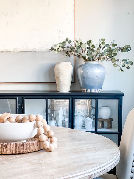My spring dining room from last year!! The blue vase is a perfect statement piece!! I love the Orion bowl with the beads spilling over too! My round dining room table, black sideboard, and everything is linked here. 

#LTKSeasonal #LTKhome #LTKstyletip
